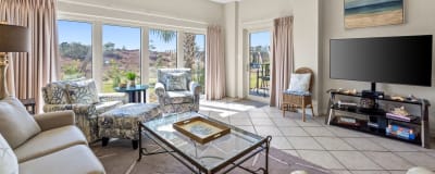 Spacious living area with plenty of seating, big screen TV and beautiful views.