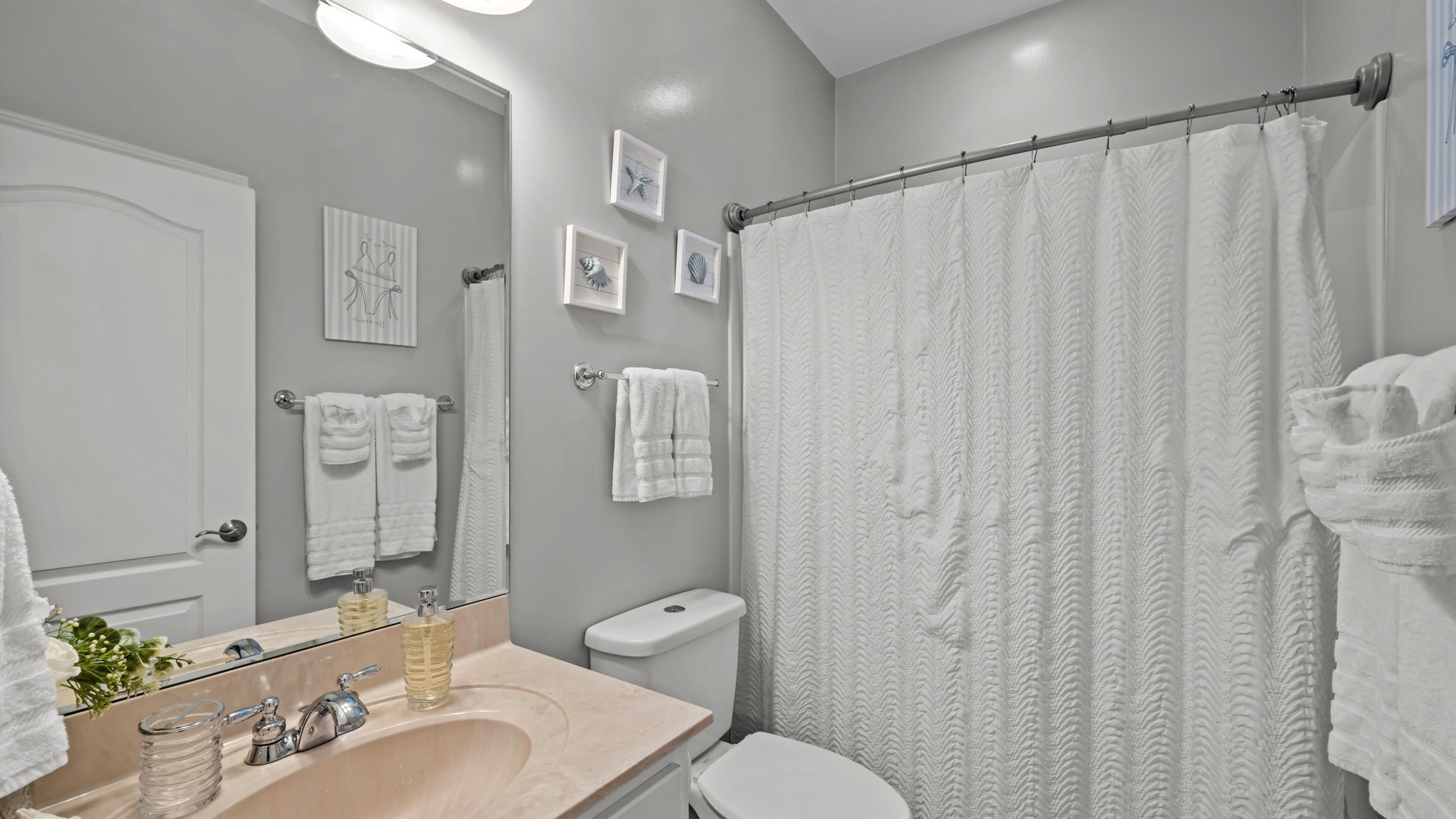 Clean, calm, and beachy — this extra bathroom is situated between the two extra bedrooms, the perfect place to refresh and recharge.