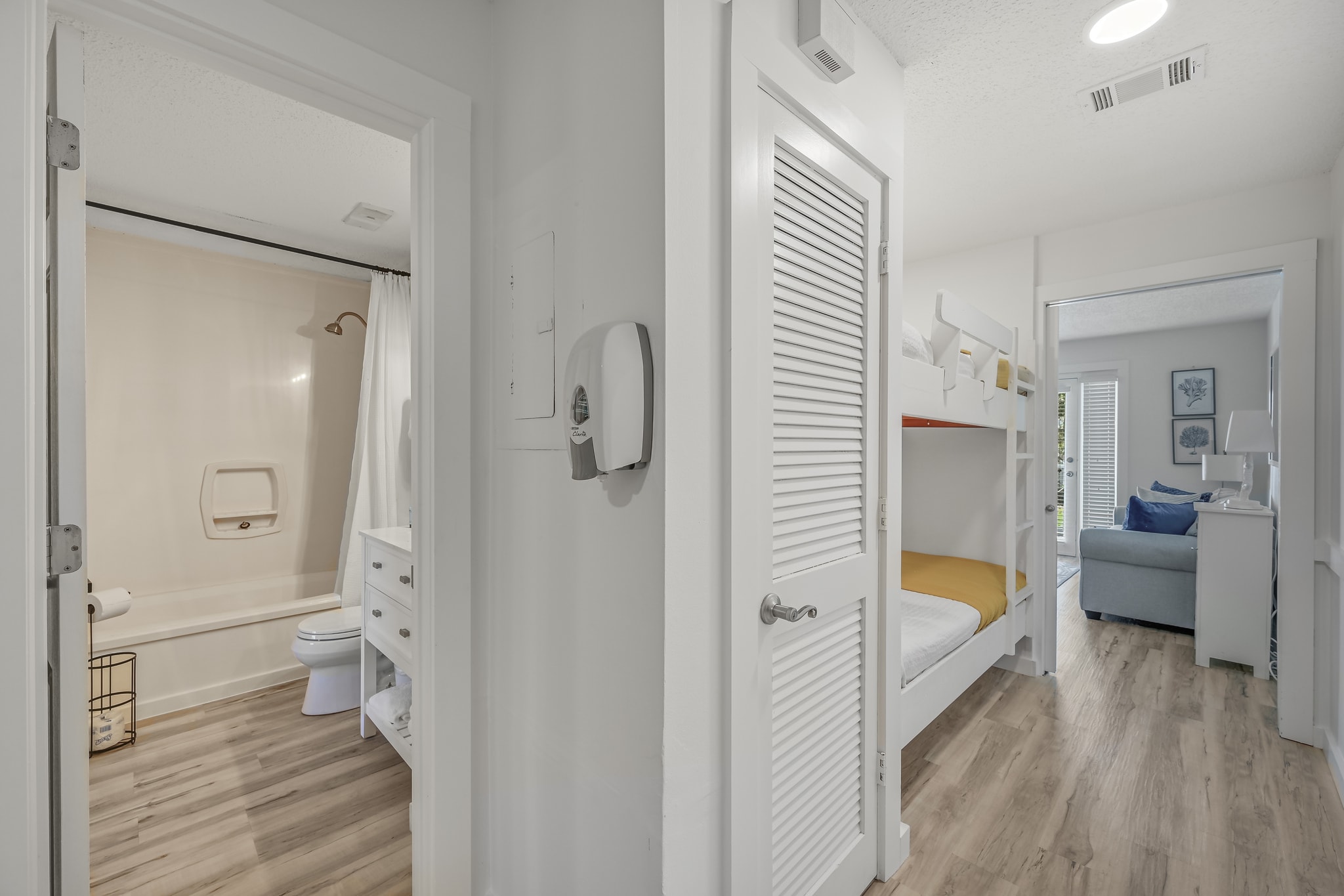 The functionality of the flow of the condo is perfect for evyone to have their own space.  This shows the ensuite master bath with another access off the hall, the bunk beds and living room - separated by a pocket door.  