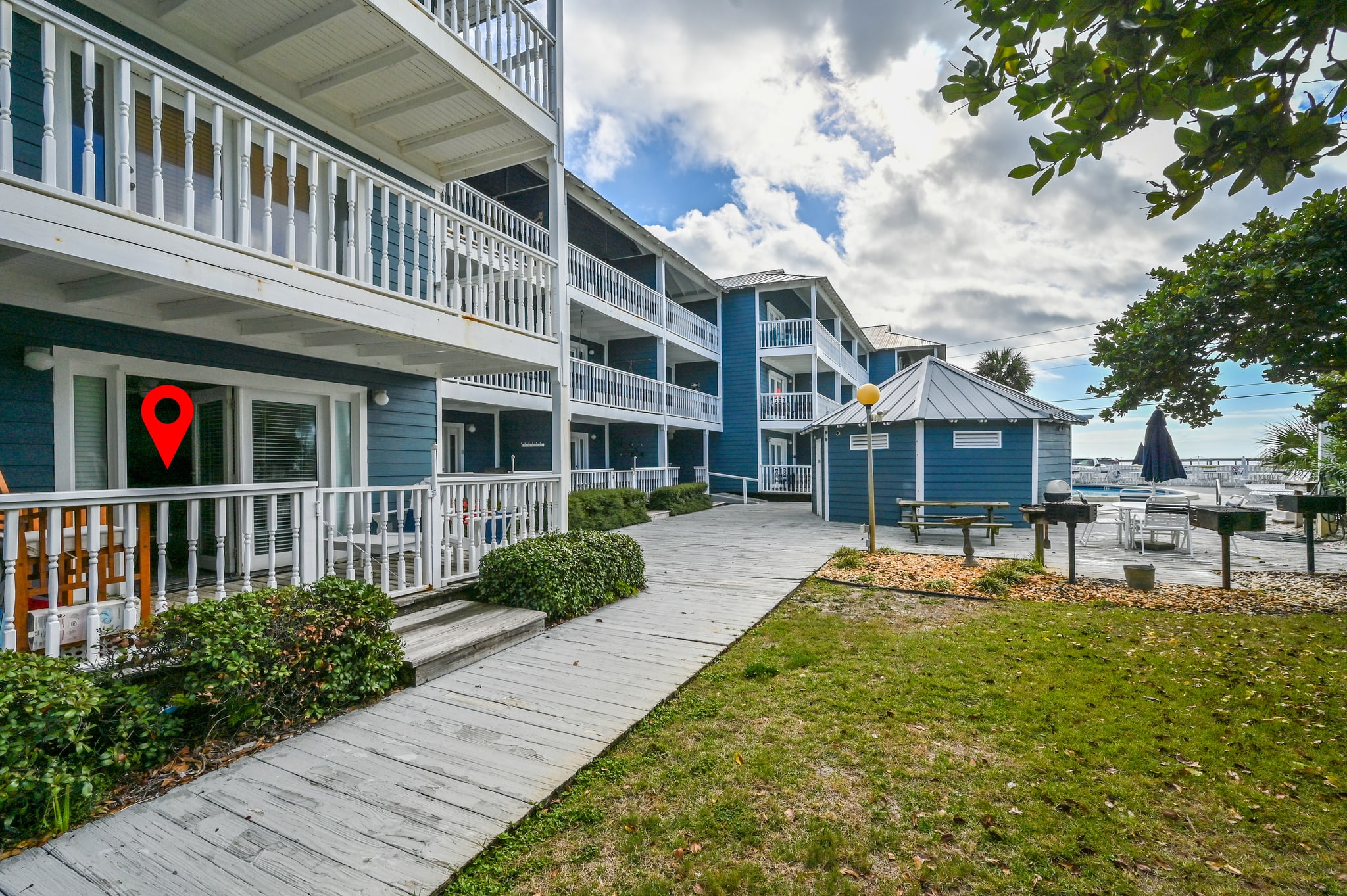 Large patio with one step for easy accessibility. View of cabana and peak-a-poo view of the Gulf and the pool with lush greenery for privacy. Beach access is just steps away from the featured cabana. 