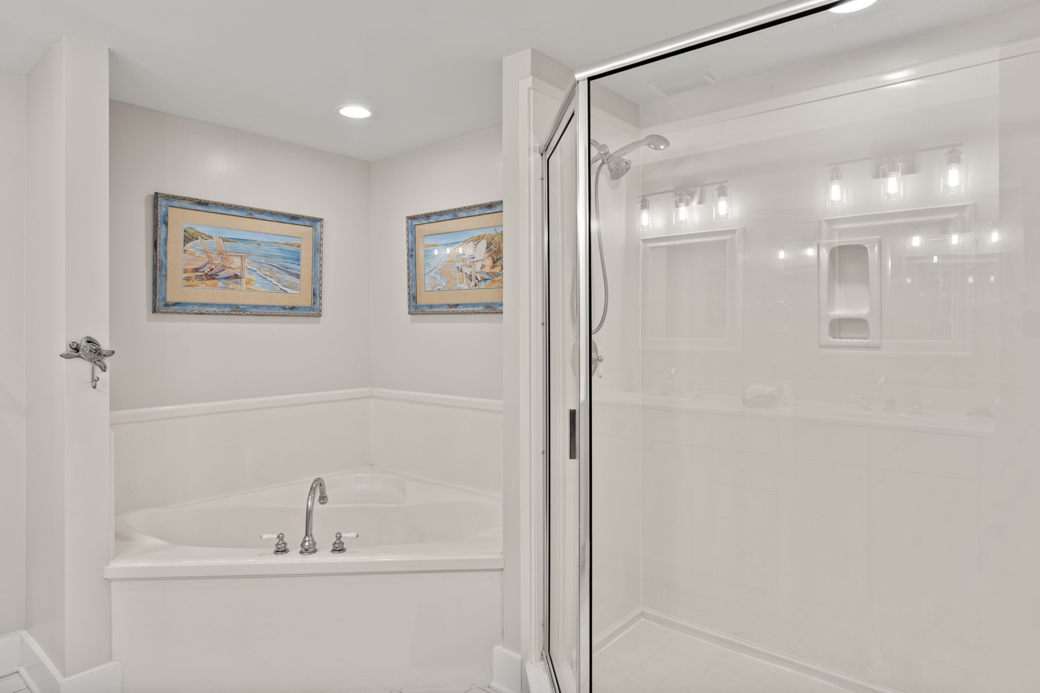 Master bathroom with double sink, tub, and large walk in shower