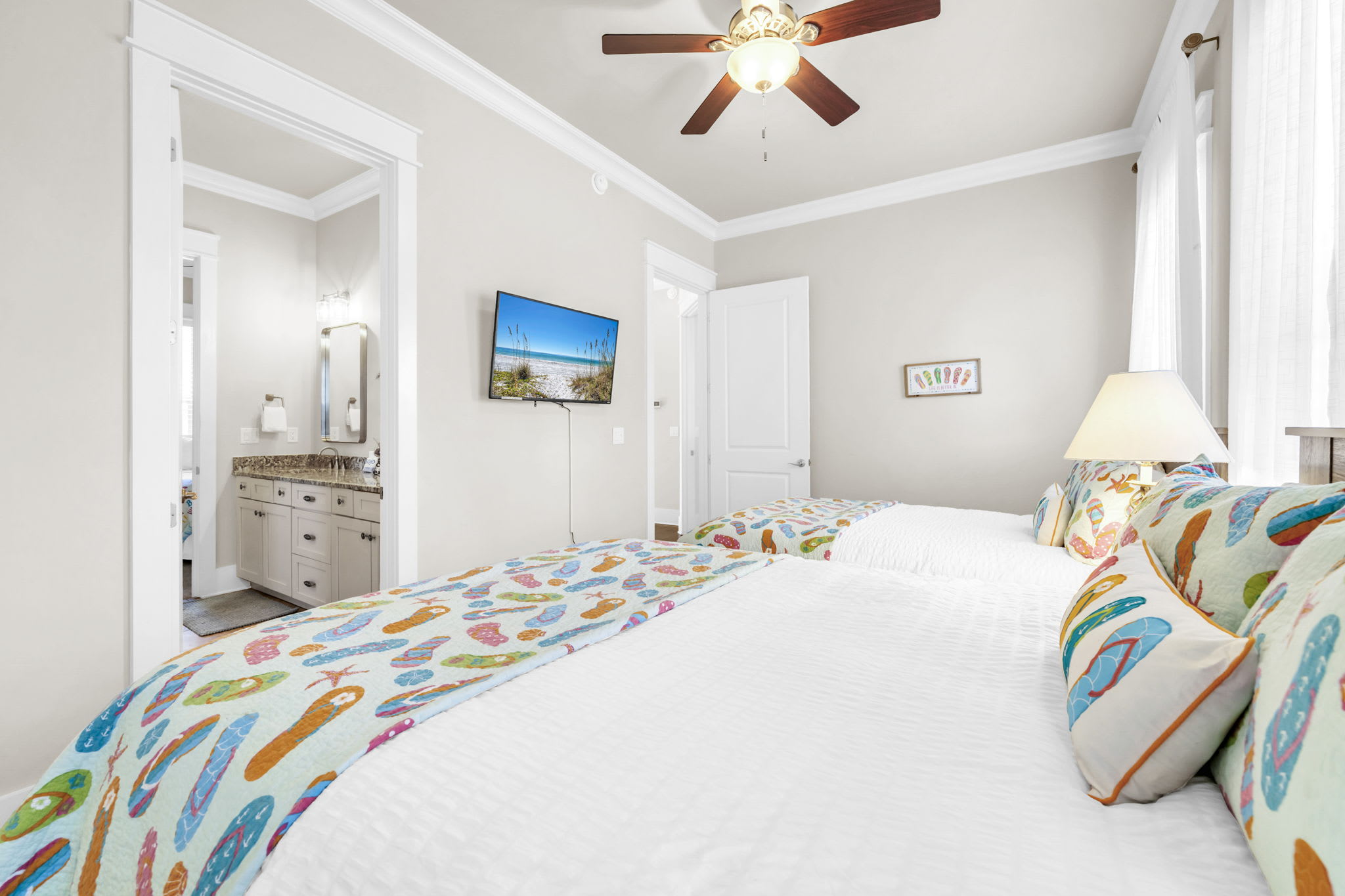 Second floor 2 queen beds with closet space and smart TV.