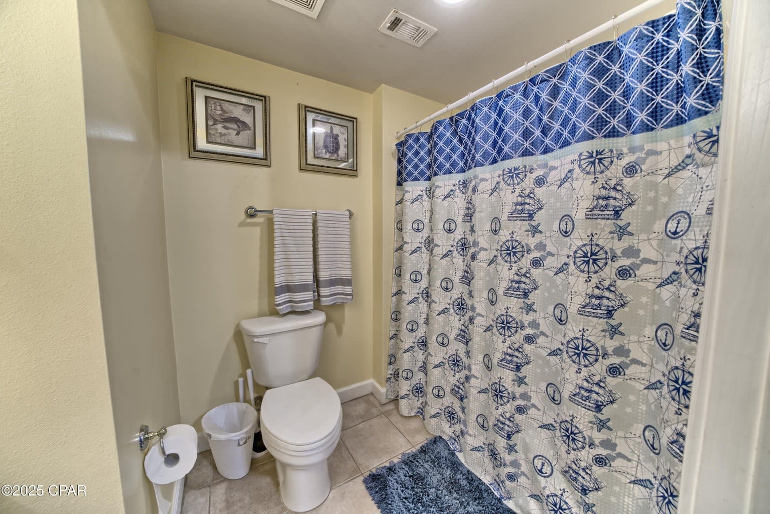 Master bath continues the beachy theme. Tub/shower combo. 