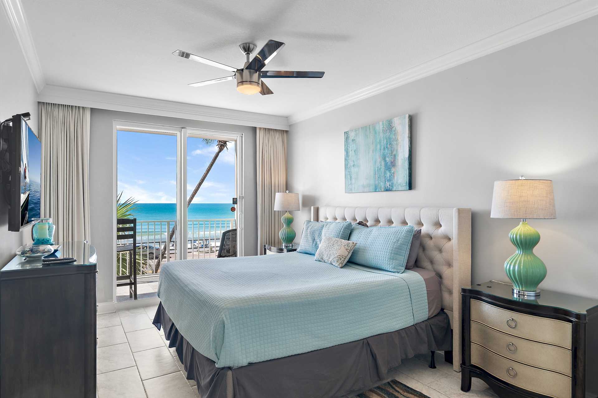 King primary suite with balcony access and ocean views