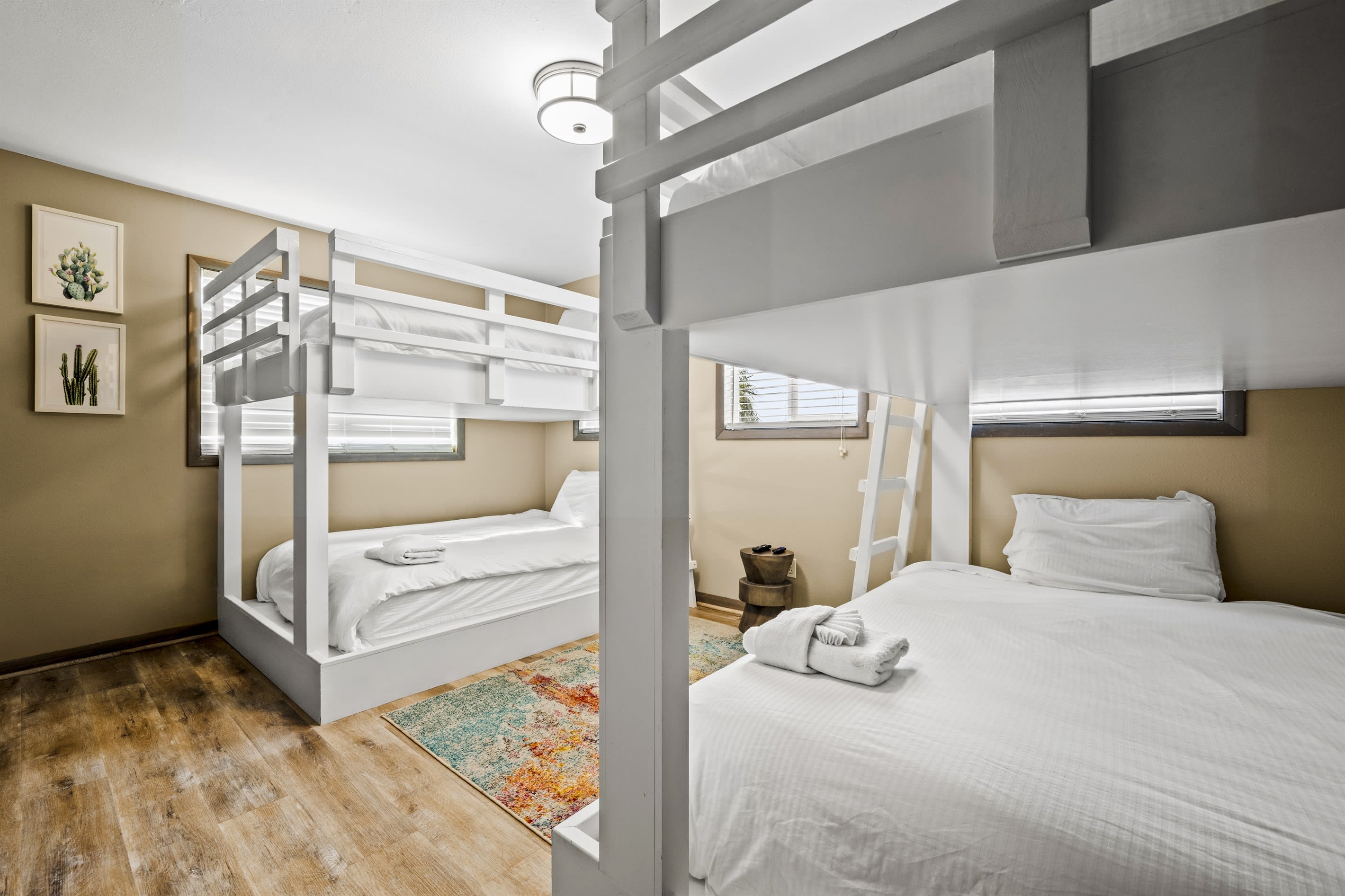 This room features 4 queen beds arranged in 2 bunkbed sets. Perfect for large families, group of friends or guests who want to maximize space while enjoying a good night sleep.