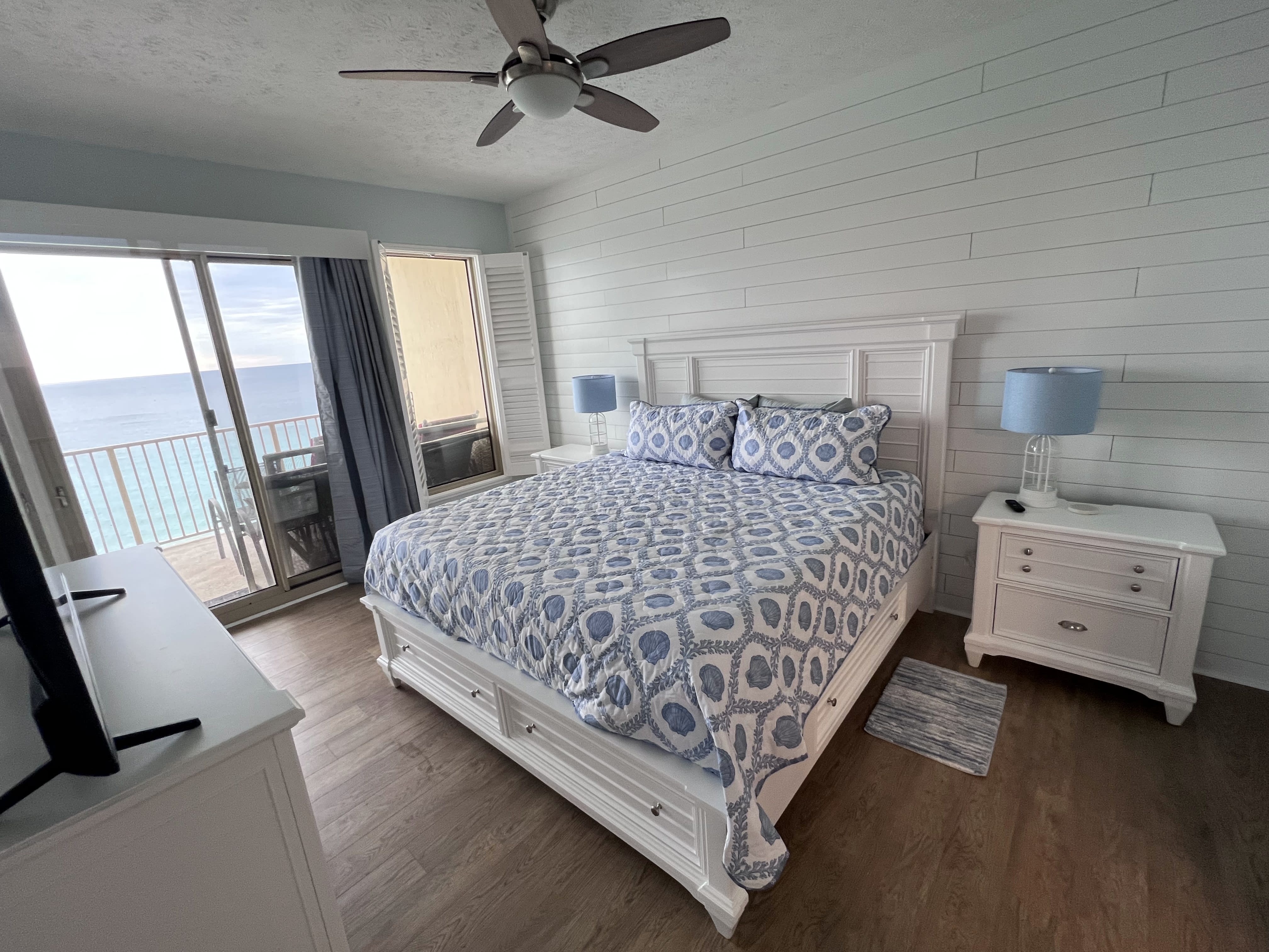 Master Bedroom-King Bed 55" TV with Gulf view and balcony access shiplap wall