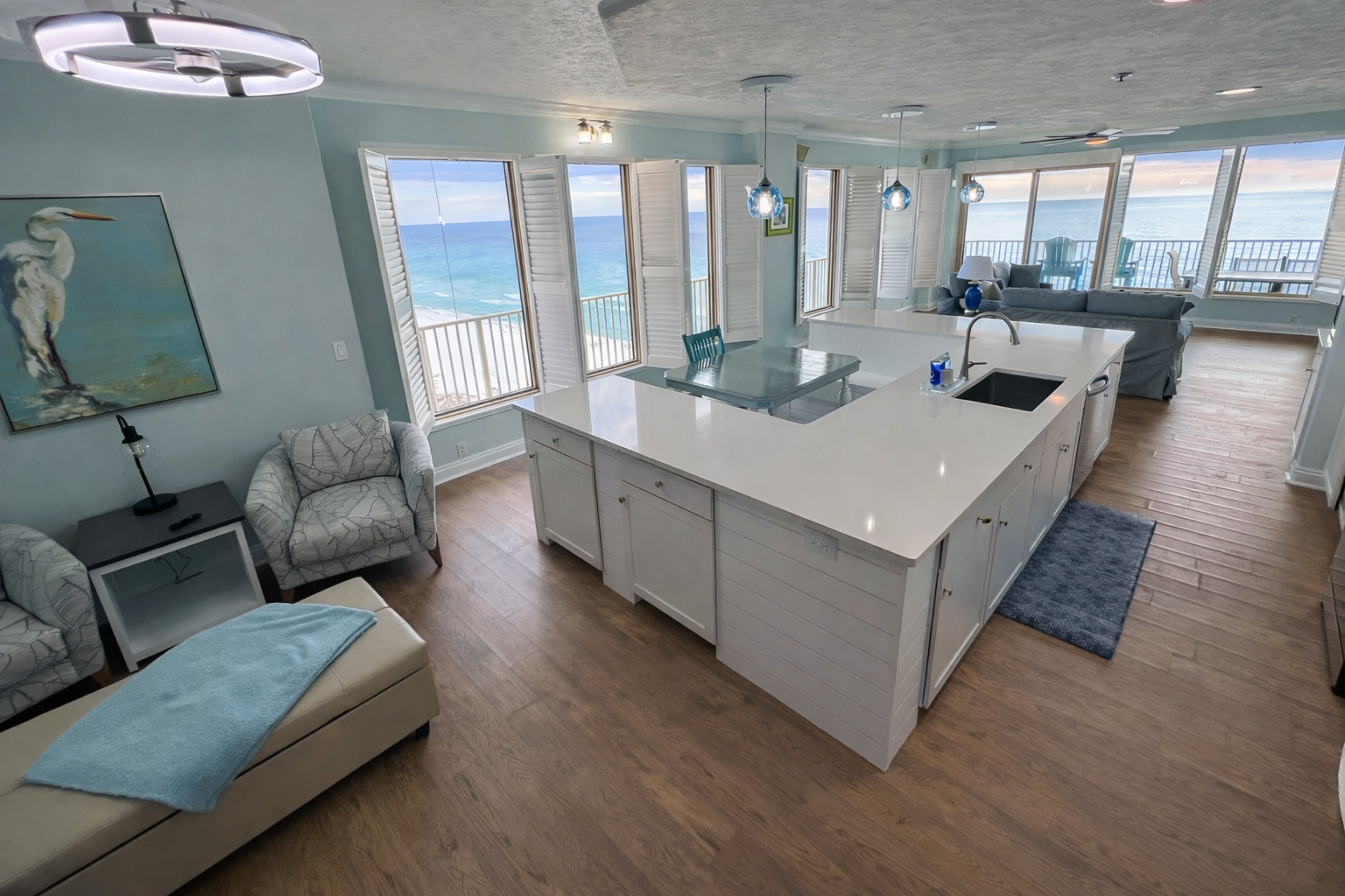 Newly renovated large open kitchen has a u-shaped island w large farmhouse sink