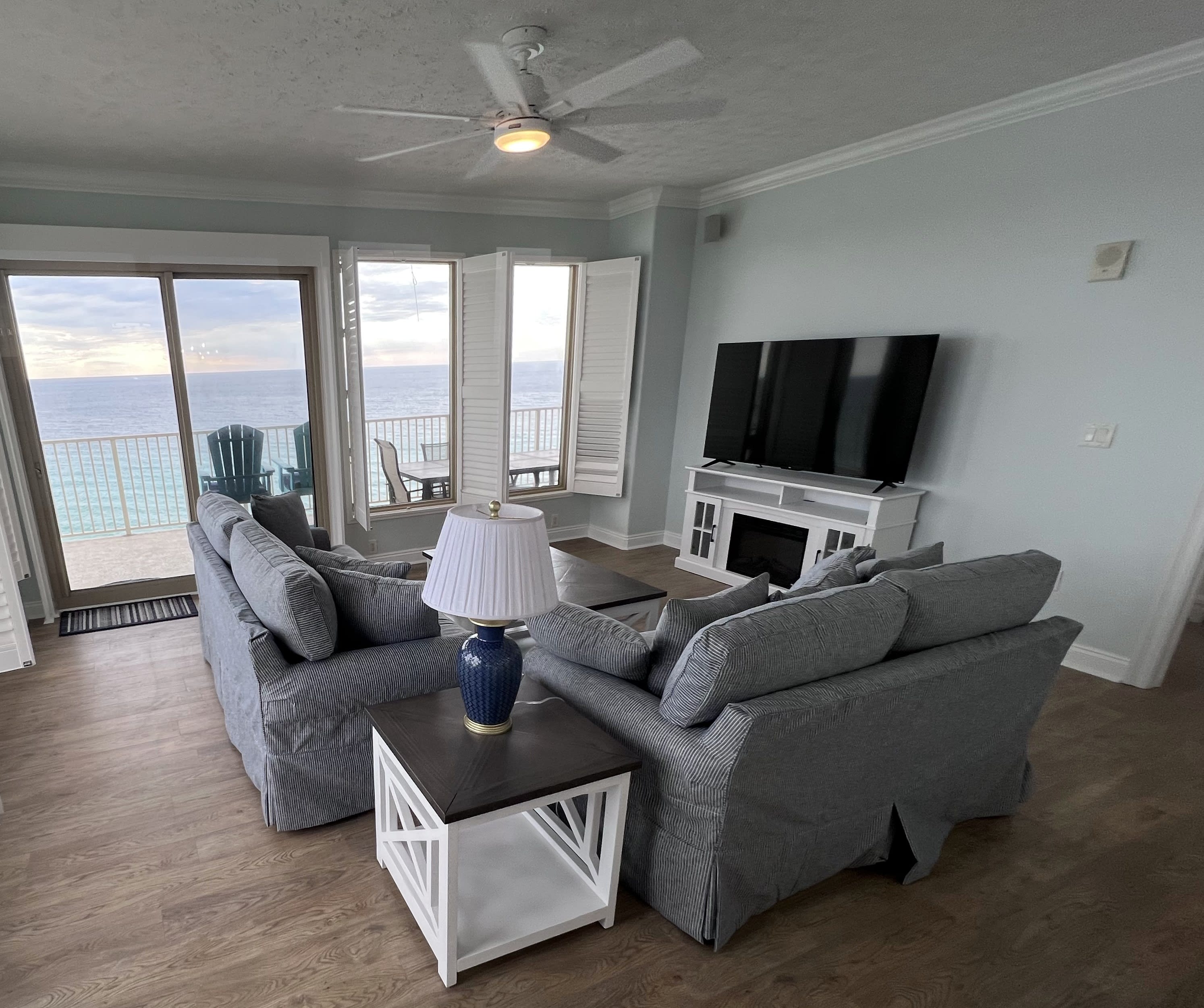 New living room furniture &amp; 65" TV on fireplace overlooking the Gulf