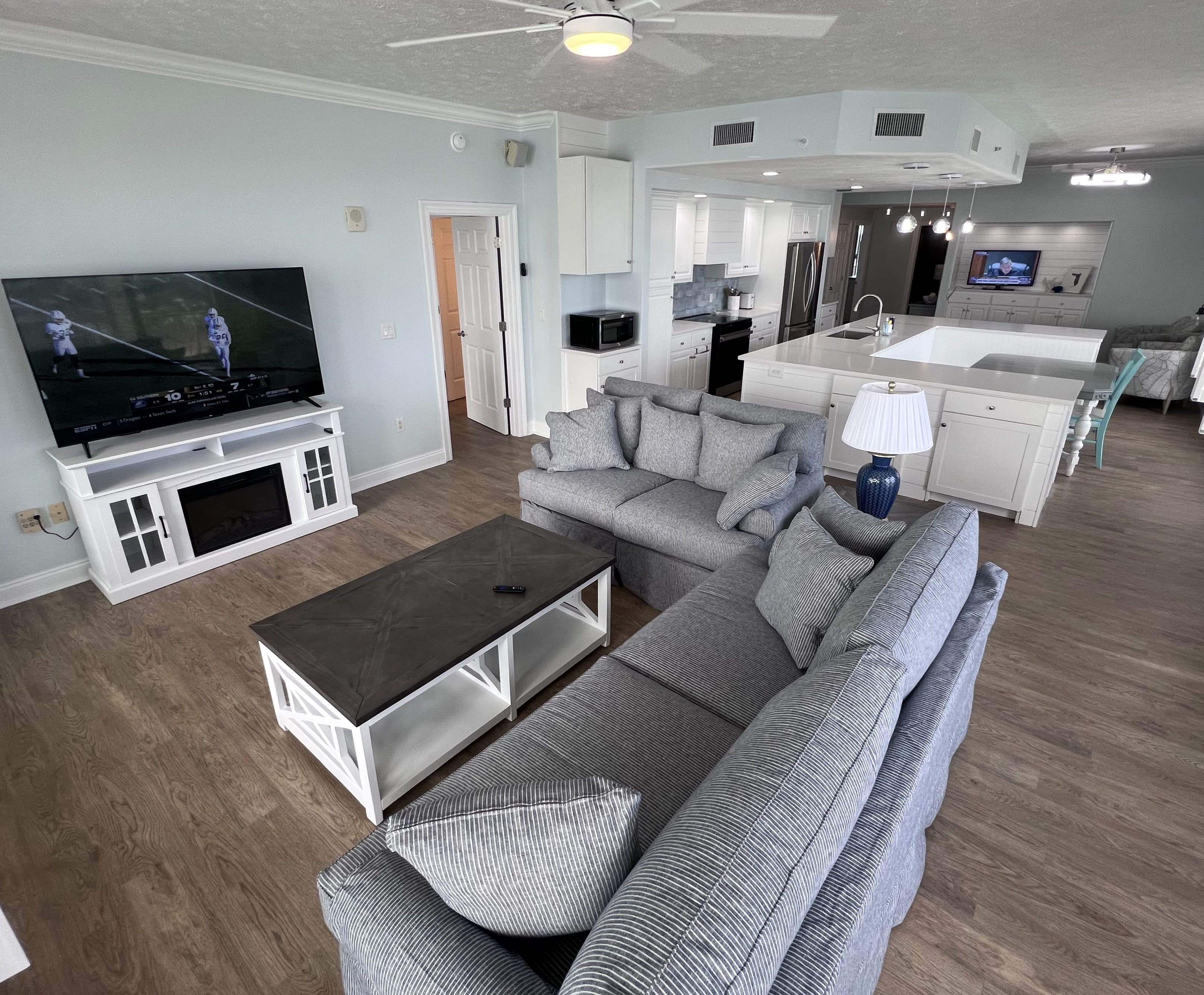 New living room furniture &amp; 65" TV on fireplace overlooking the Gulf