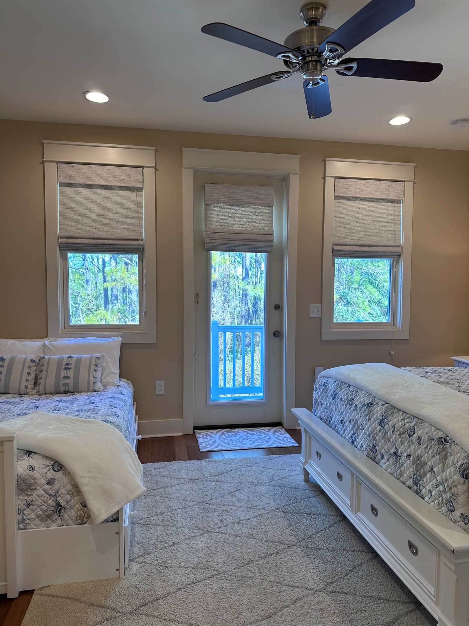 View of the Queen and Full size beds from the en suite bathroom, looking towards the private balcony.