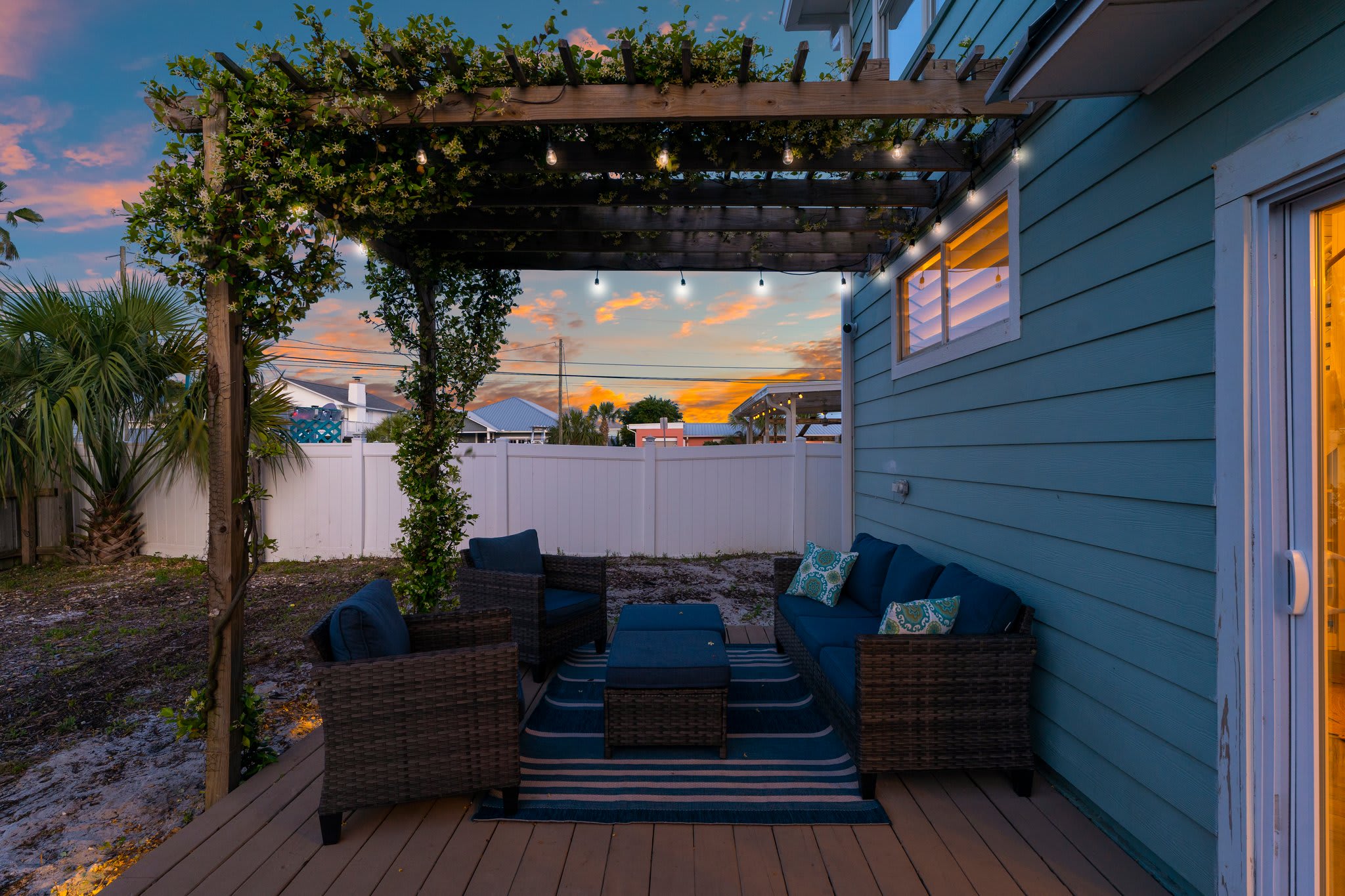 Enjoy the outdoor seating on the back deck under the pergola.