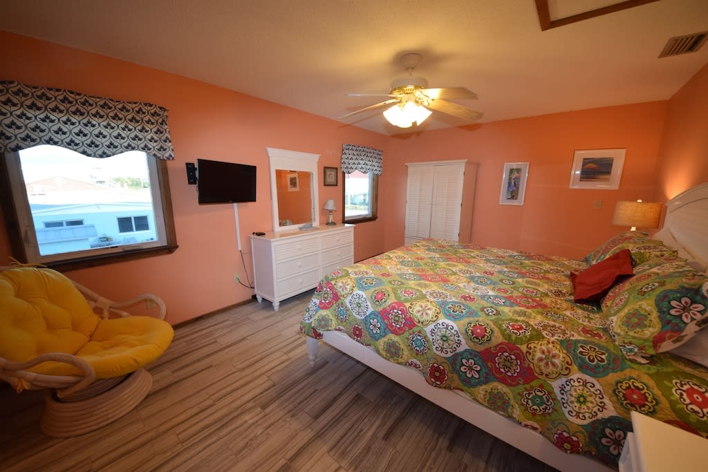 Master bedroom with king bed and attached bathroom