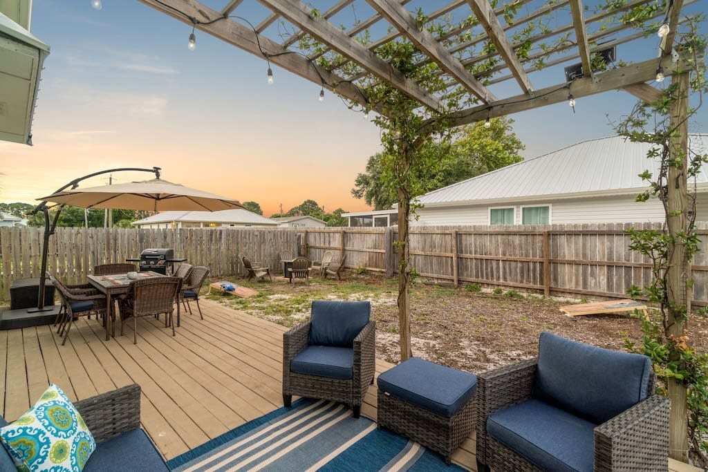 Enjoy the outdoor seating on the back deck under the pergola.
