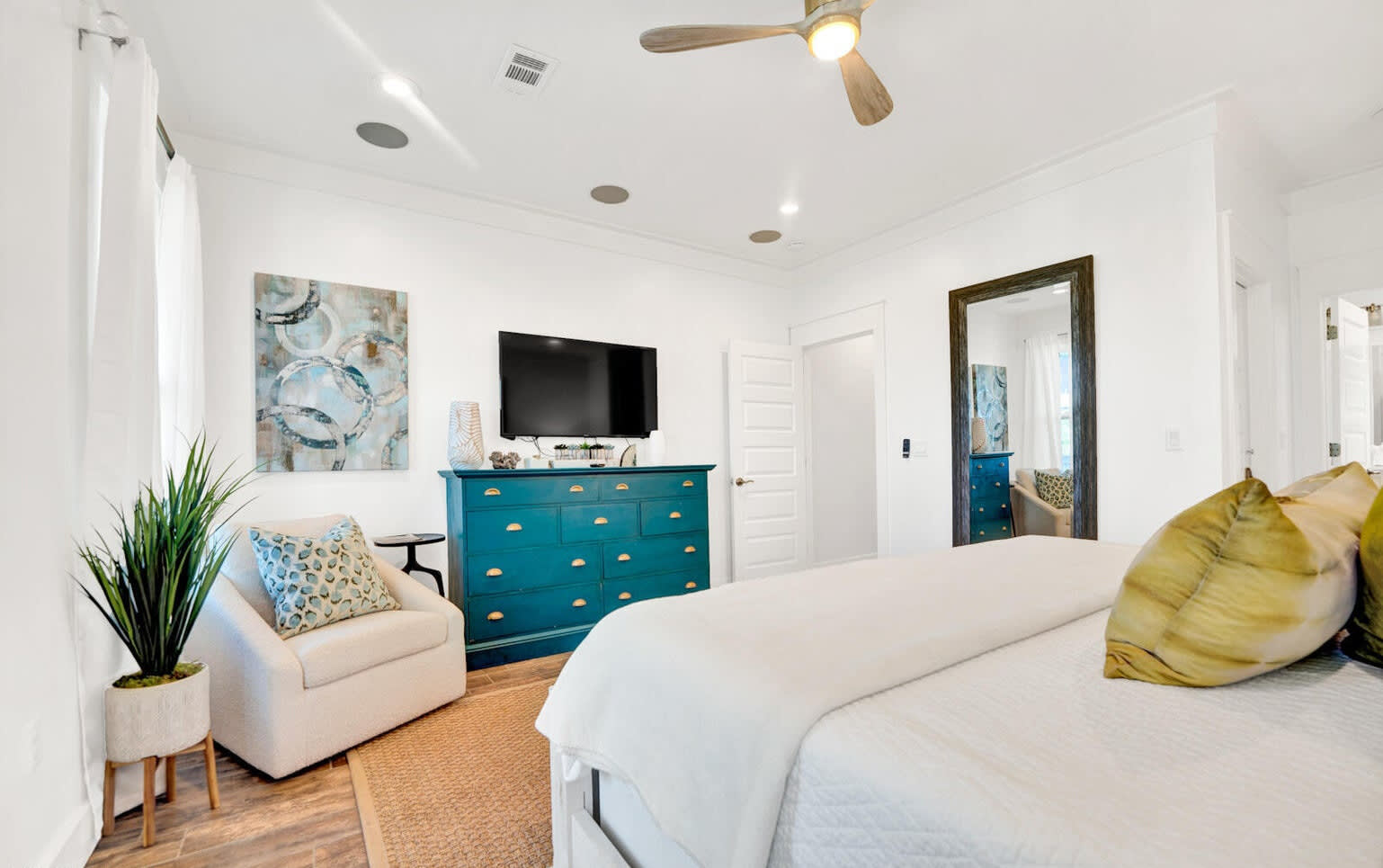 Primary retreat with ceiling fan, private balcony, ceiling fan and 55" TV