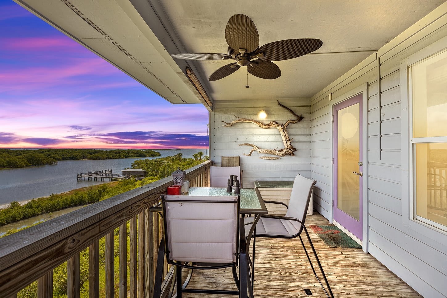 Cedar Key Tranquility's Balcony with five high top chairs and fan.