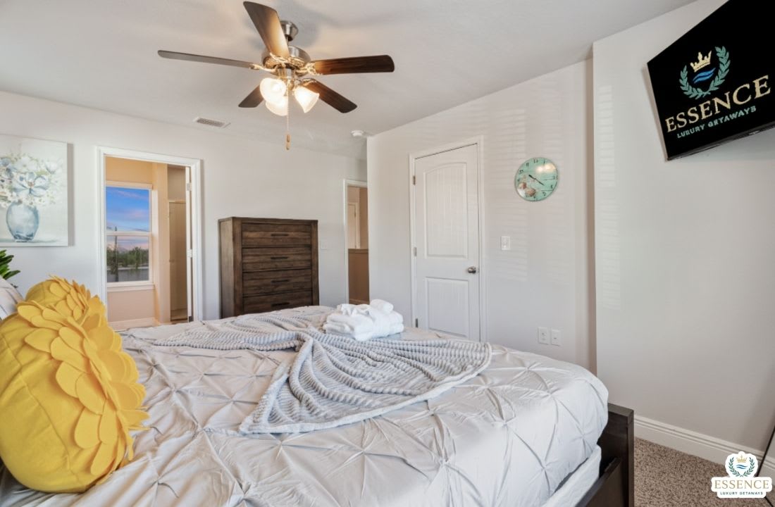 Relax in this serene bedroom featuring a plush bed, stylish wood headboard, smart TV, and soft natural light. Thoughtfully designed for comfort and rest, it&rsquo;s the perfect retreat after a day of adventure or work.