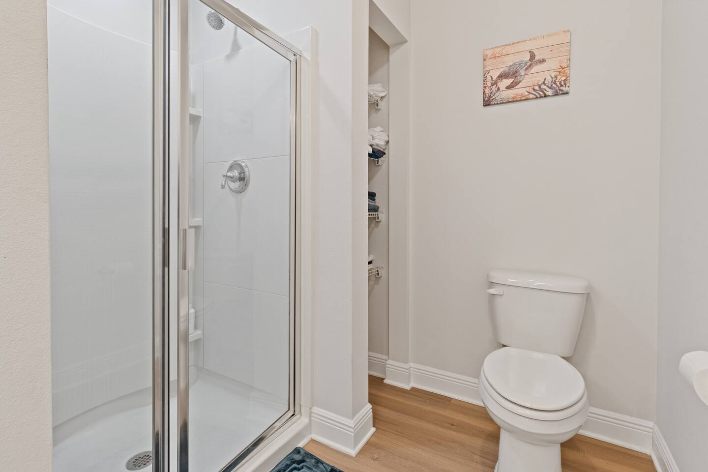 Bright and spotless bathroom vanity with granite countertop, large mirror, and extra storage. Thoughtfully stocked with essentials and fresh towels for a comfortable, convenient stay