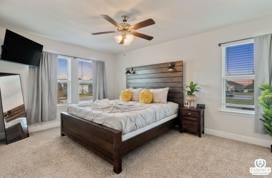 Relax in this serene bedroom featuring a plush bed, stylish wood headboard, smart TV, and soft natural light. Thoughtfully designed for comfort and rest, it&rsquo;s the perfect retreat after a day of adventure or work.