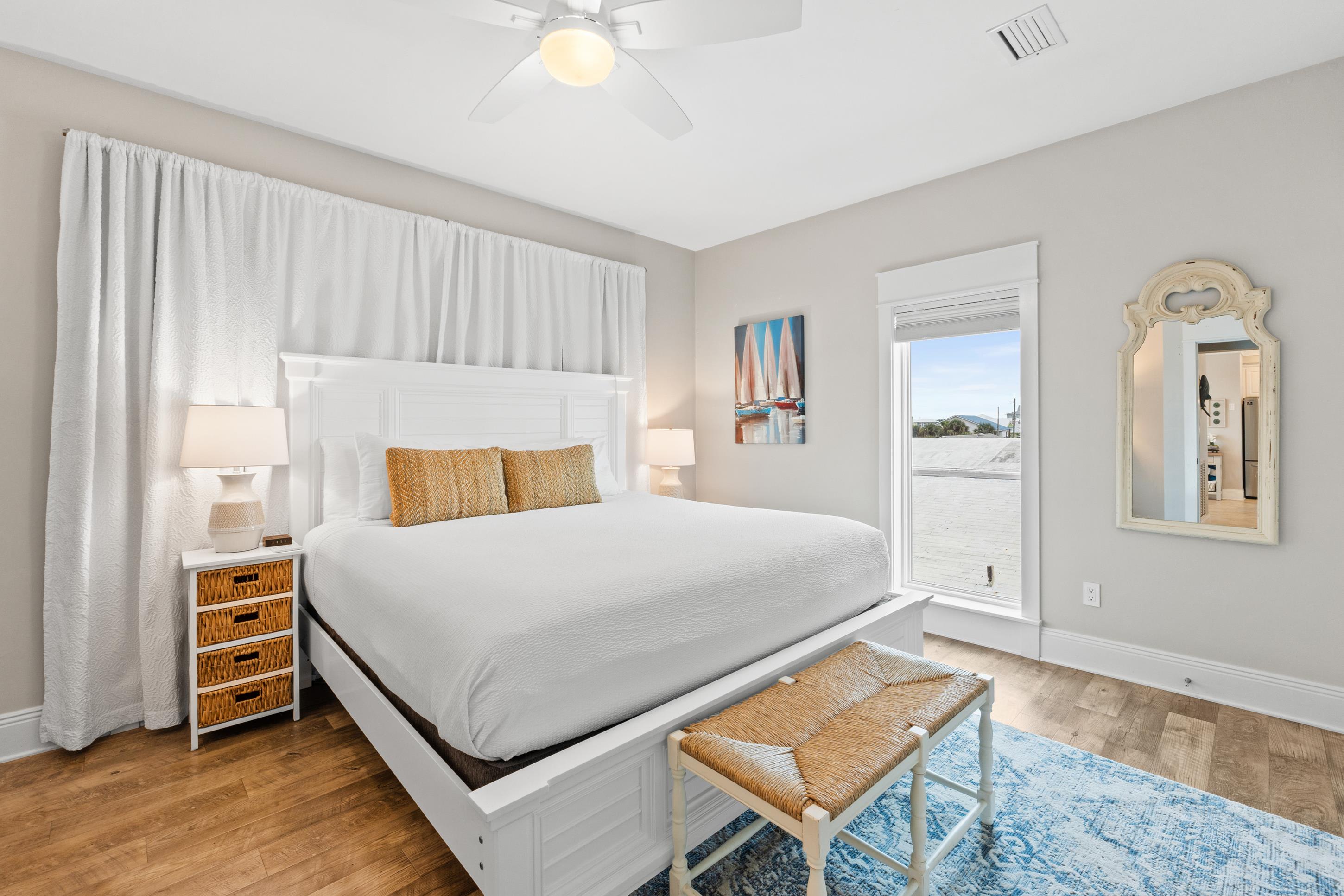 Bright 3rd king bedroom with coastal d&eacute;cor and plush bedding. Relax in comfort and enjoy peaceful mornings before stepping out to explore the beach just steps away. Perfect for couples or parents.