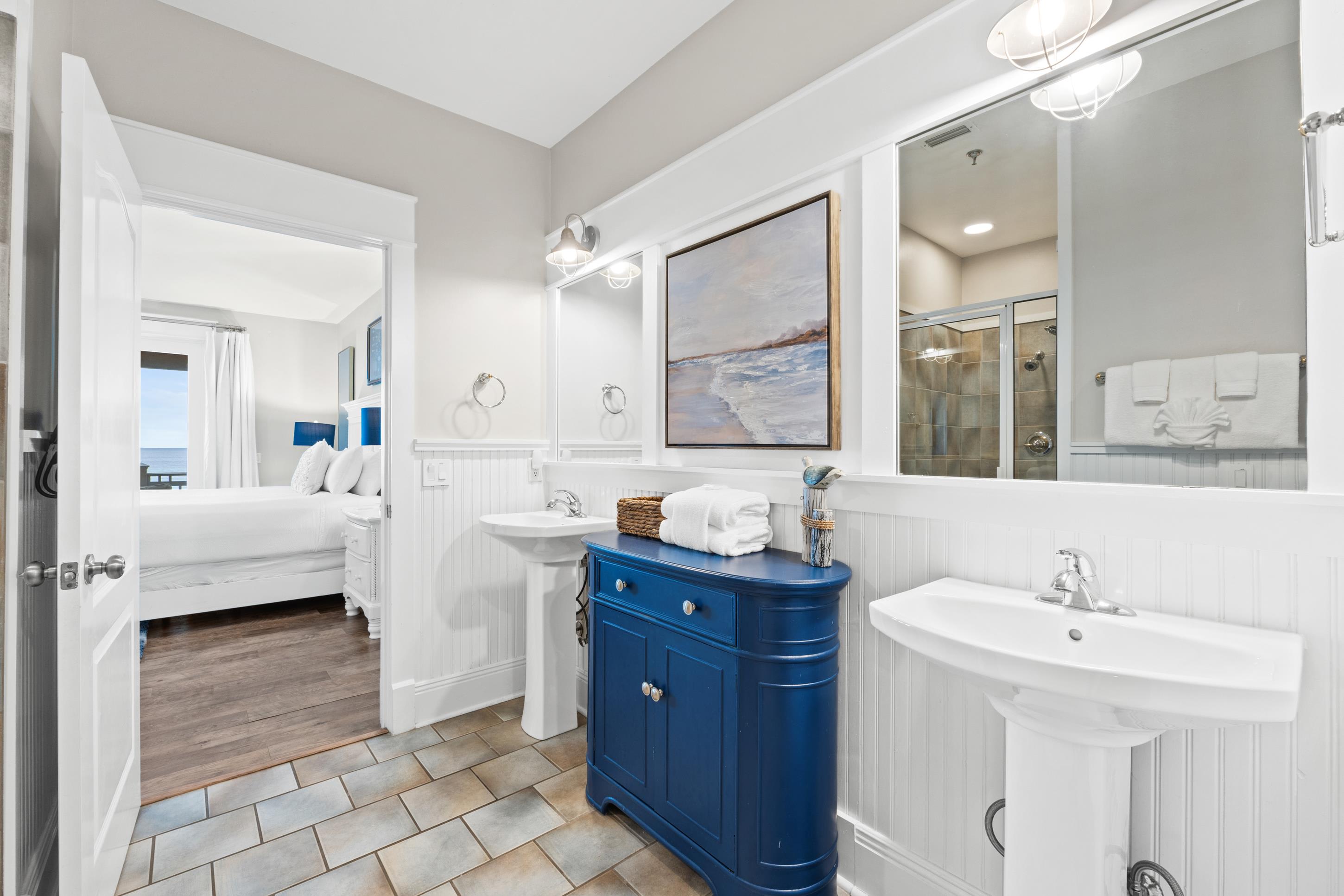 Modern bathroom with designer details, walk-in shower, and bright coastal styling. Every detail is designed for comfort and convenience during your beach getaway.