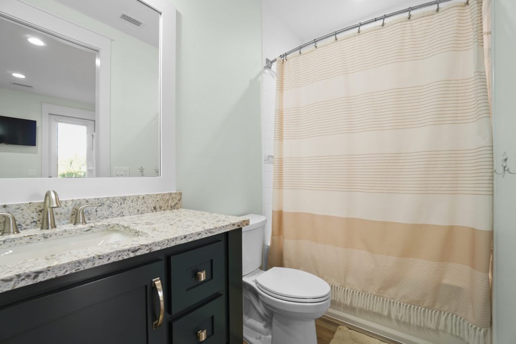 bunk room bathroom with tub and shower