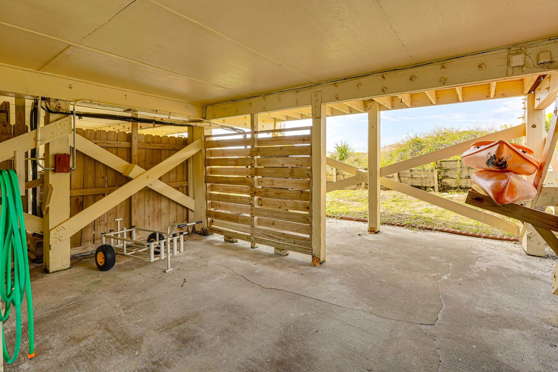 Great spot under the home. Make sure to grab the fishing cart or Kayak!