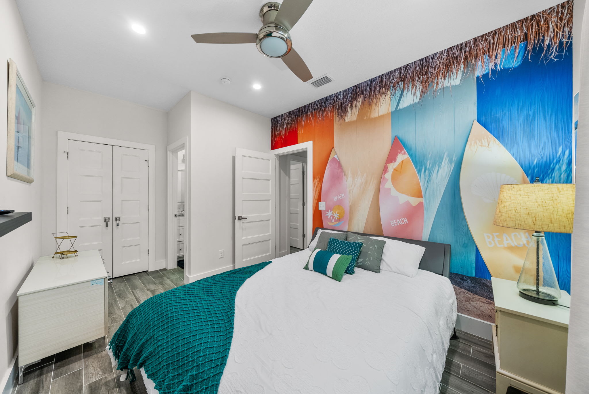 2nd bedroom with Queen bed, linens, pillows, smart TV, fan, closet, 1 roll away single bed is stored in the closet. Bathroom attached.