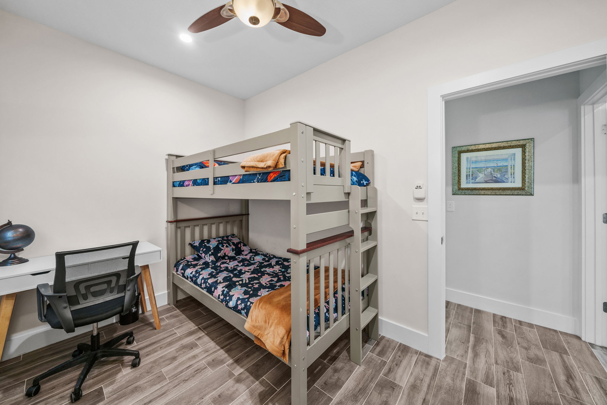 Twin over Twin bunk bed with office desk and ergonomic chair for your remote work needs.