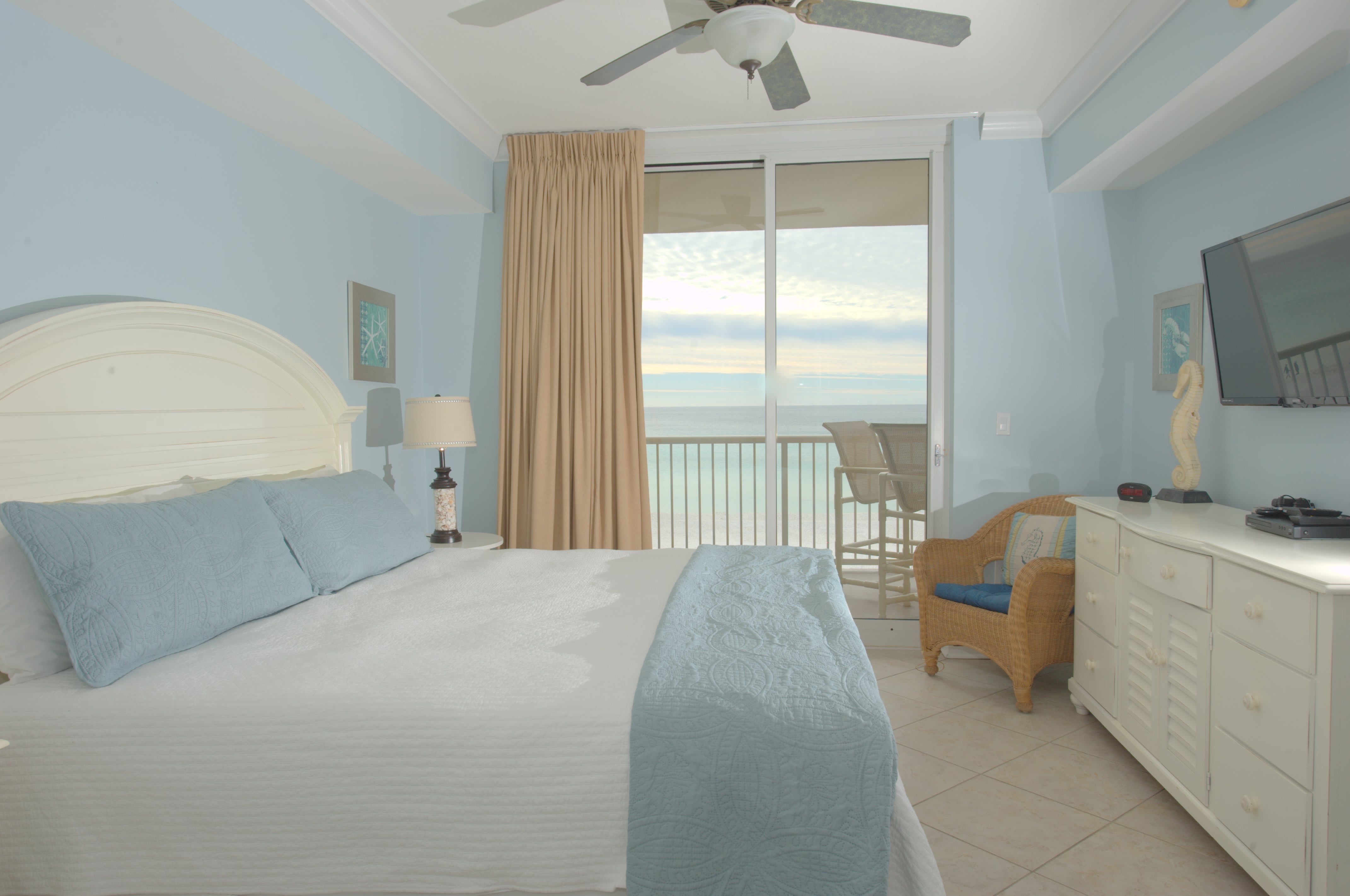 The spacious primary bedroom has a king bed and direct access to the balcony. 
