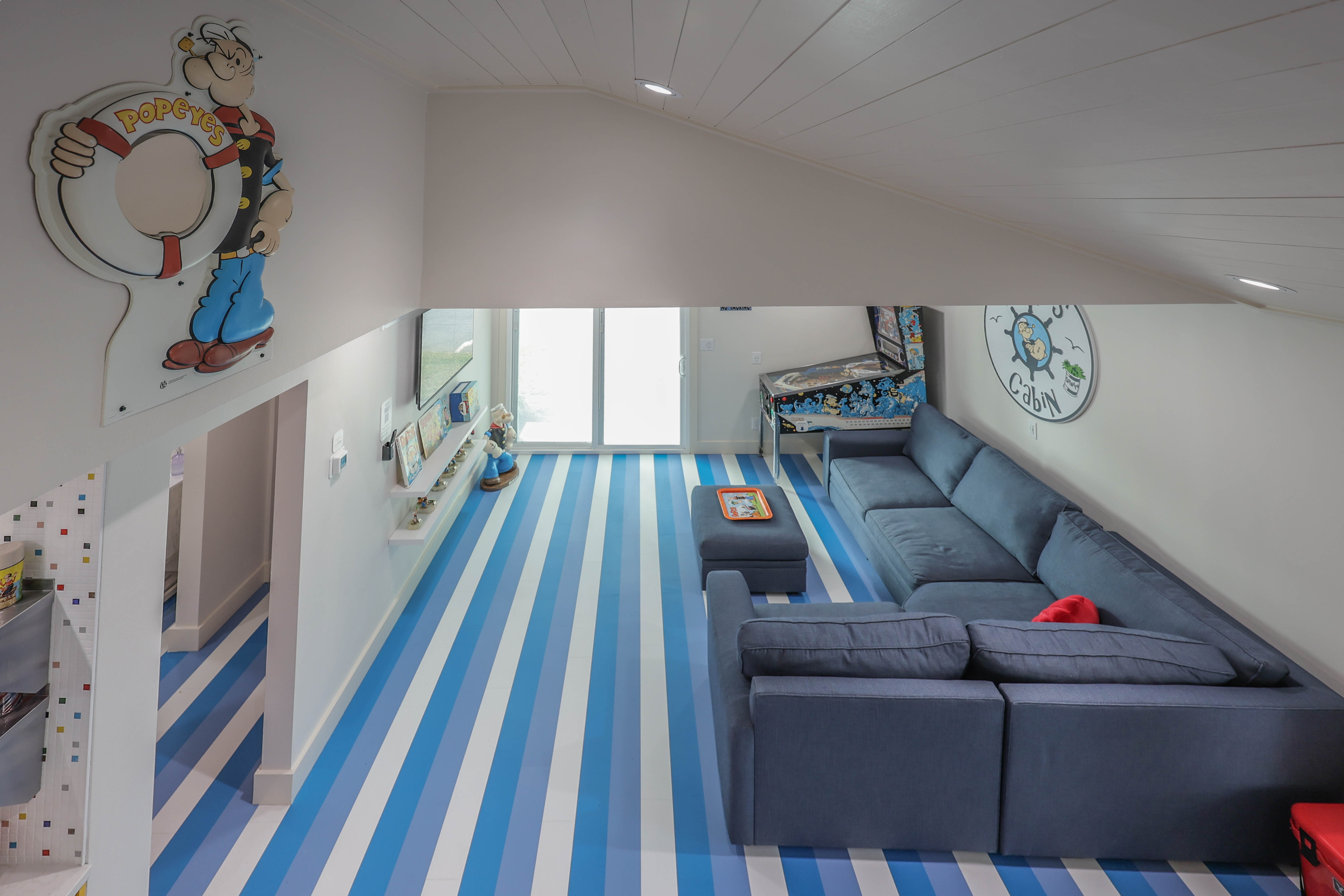 Unique Popeye-inspired space with bold striped floors clean, fun!