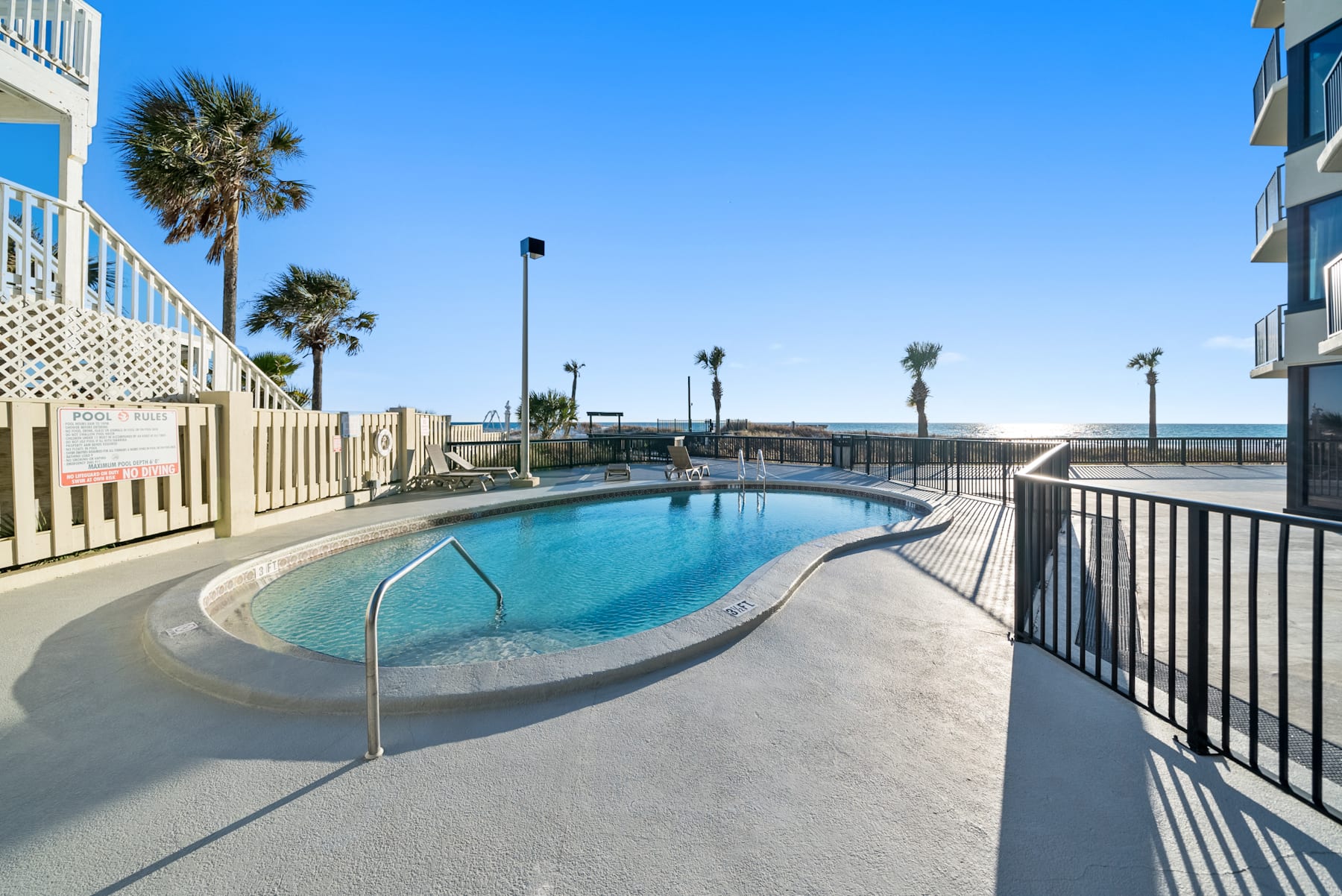 East pool deck w/private gated beach access.