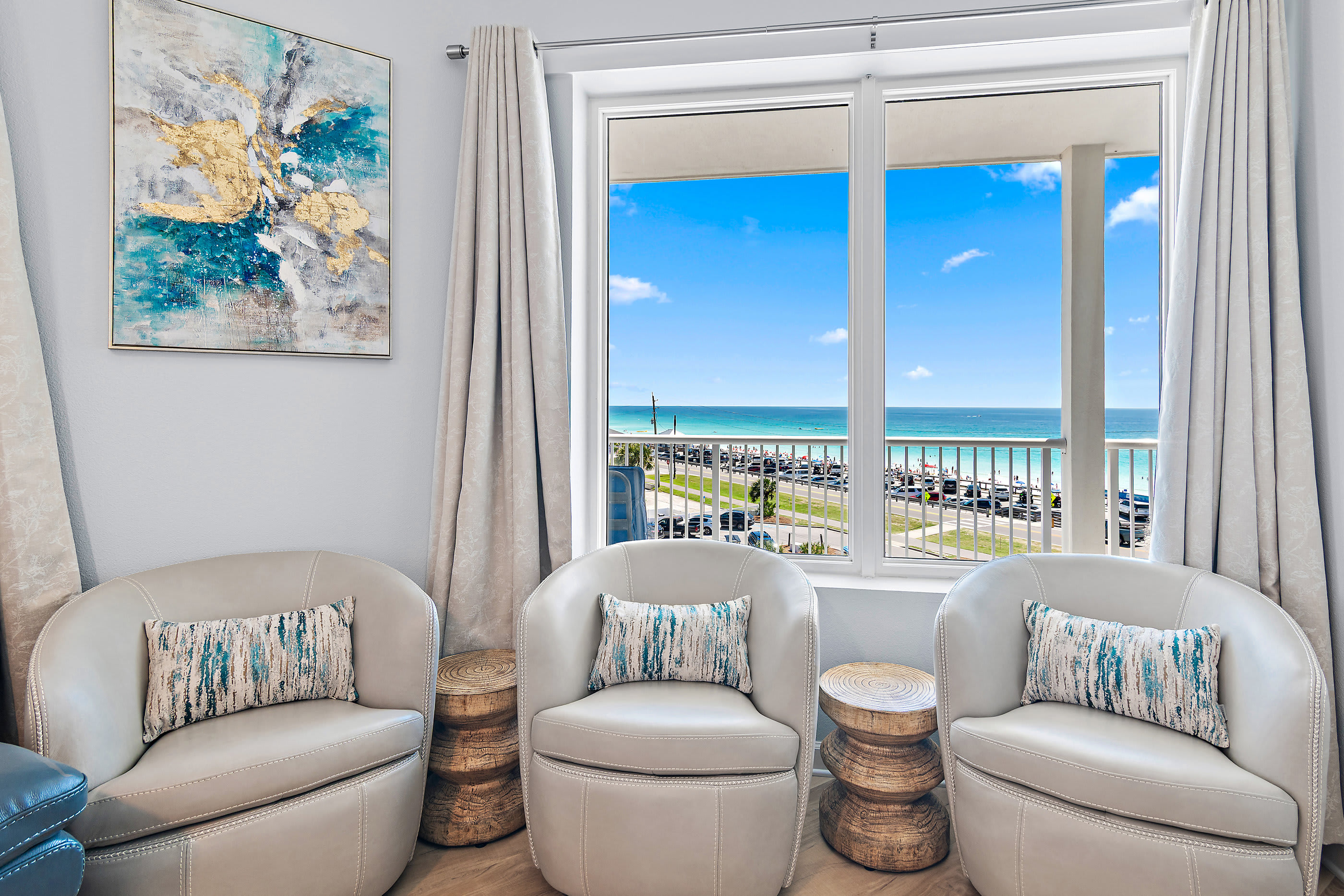 Living room with sectional, smart TV, and balcony access