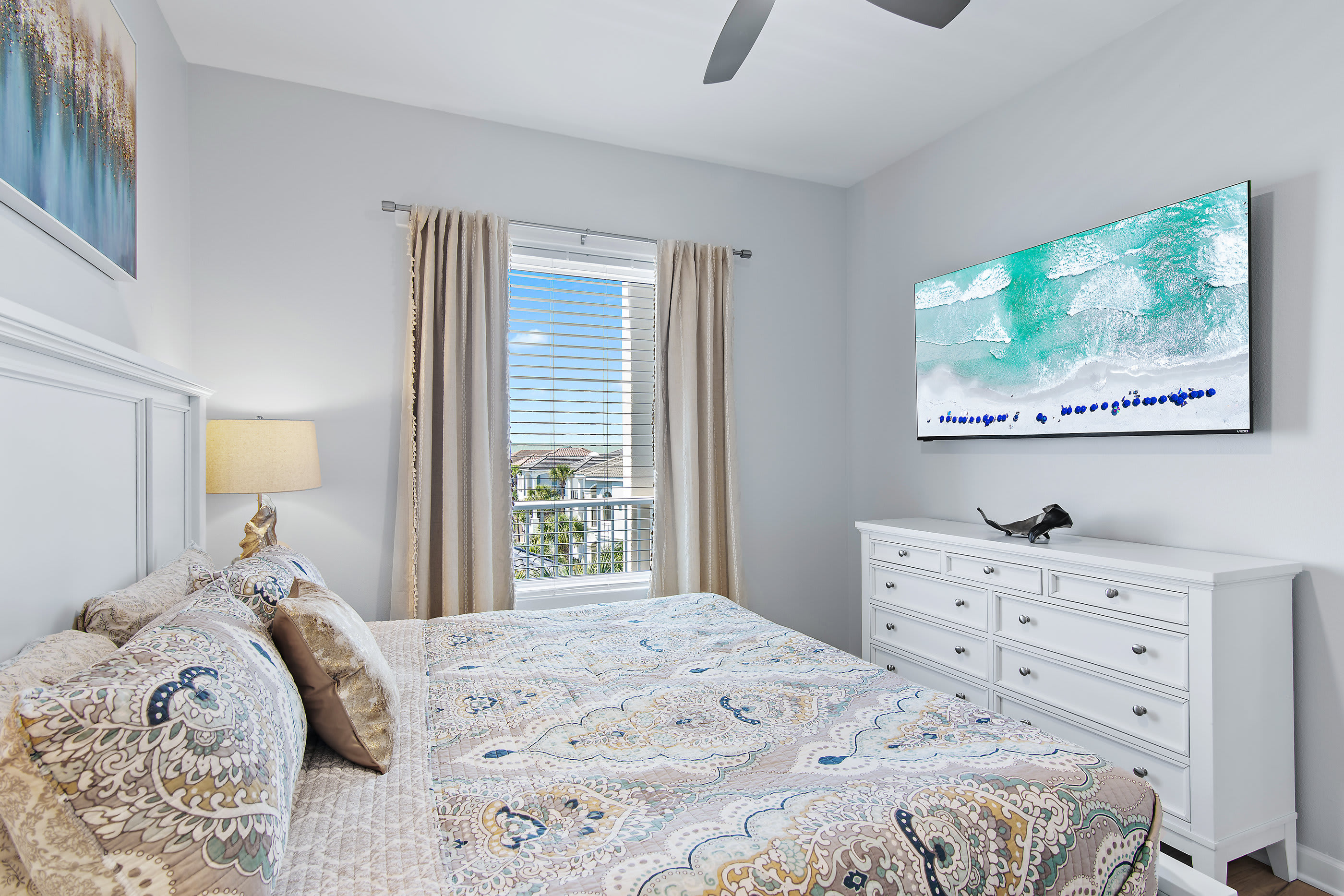 Guest king bedroom with dresser and TV