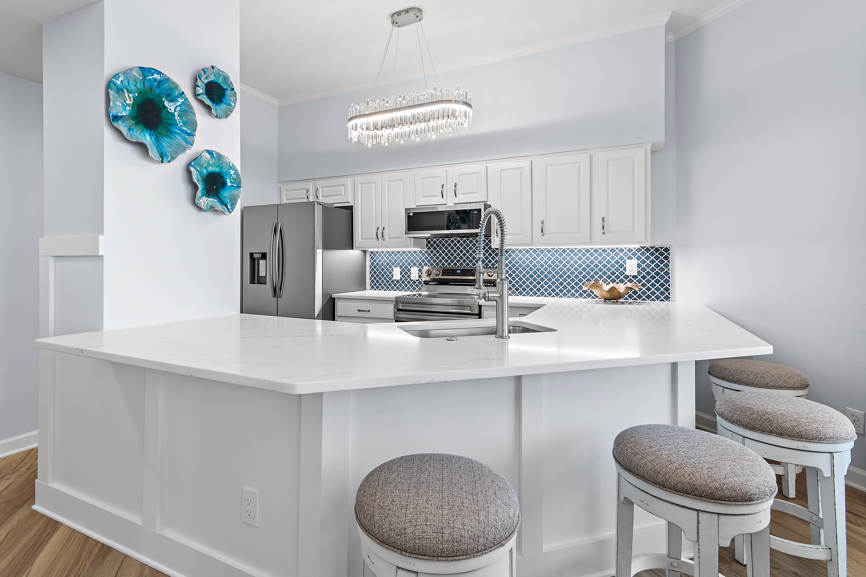 Kitchen with granite counters, stainless appliances, and bar stools
