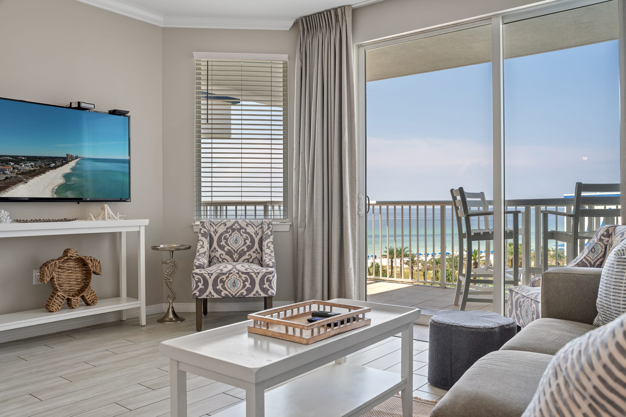 Floor-to-ceiling glass doors bring in natural light and connect to the balcony.