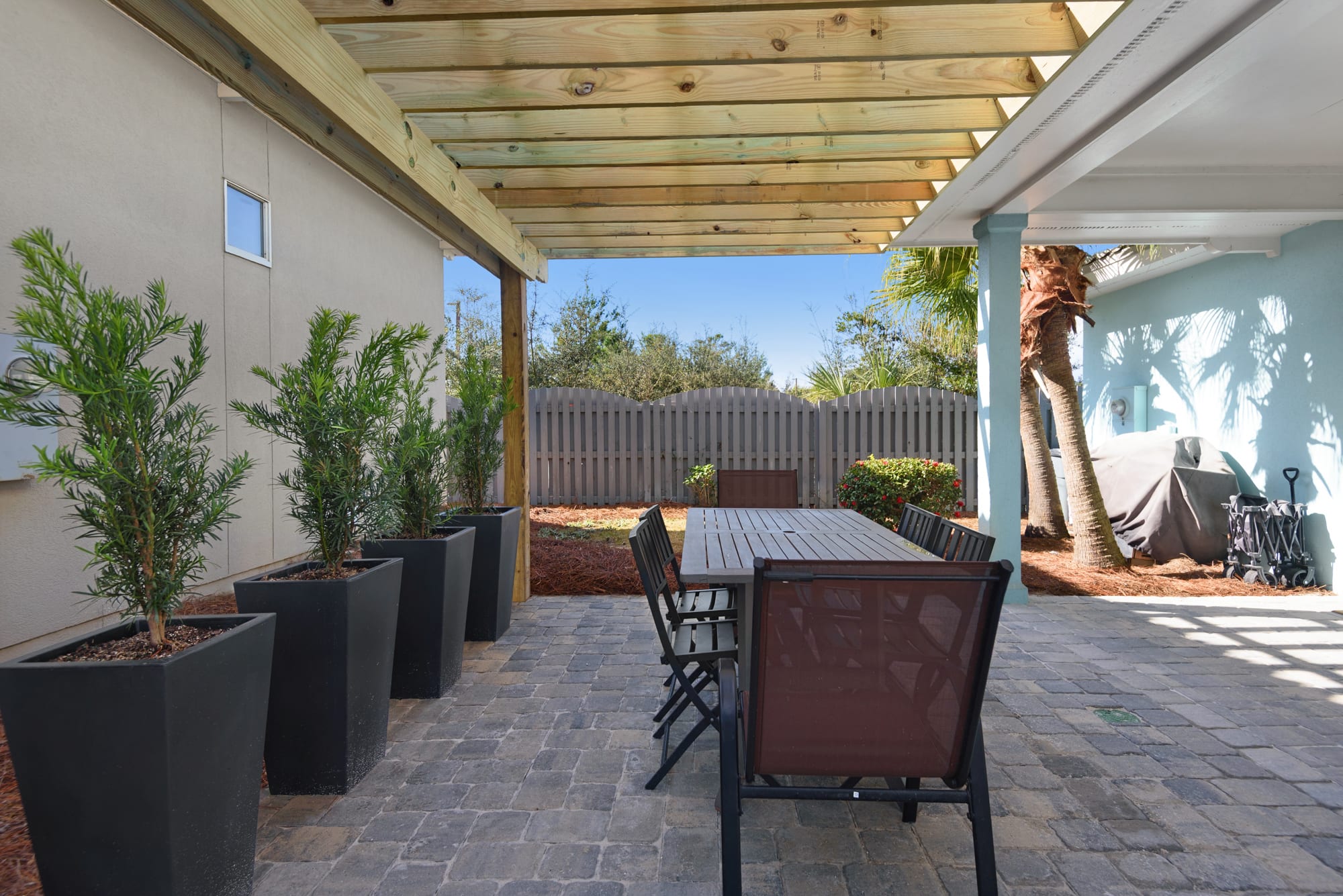 Large pavered patio with outdoor seating and grill