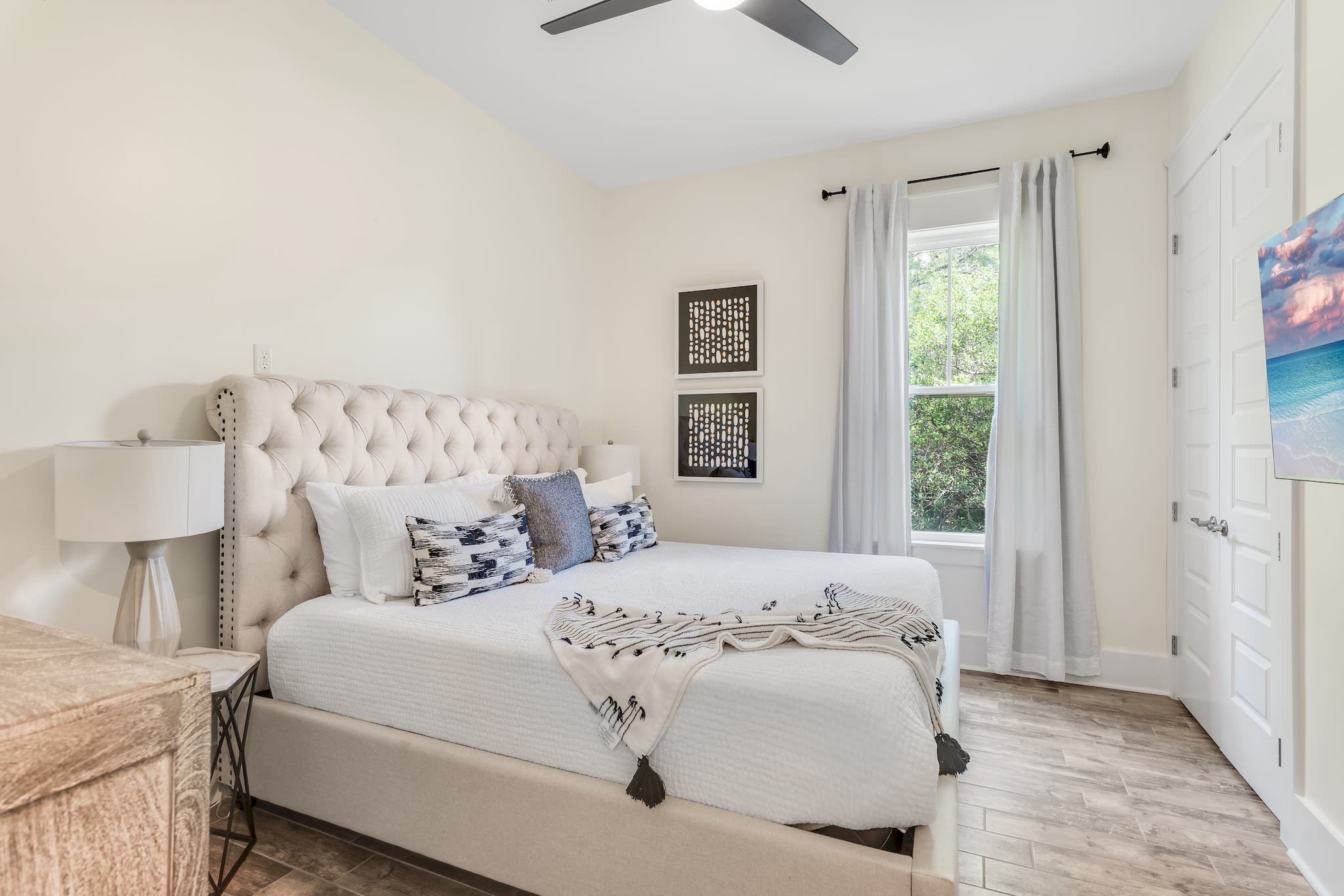 King bedroom w/ fan, 55" TV, closet & dresser.