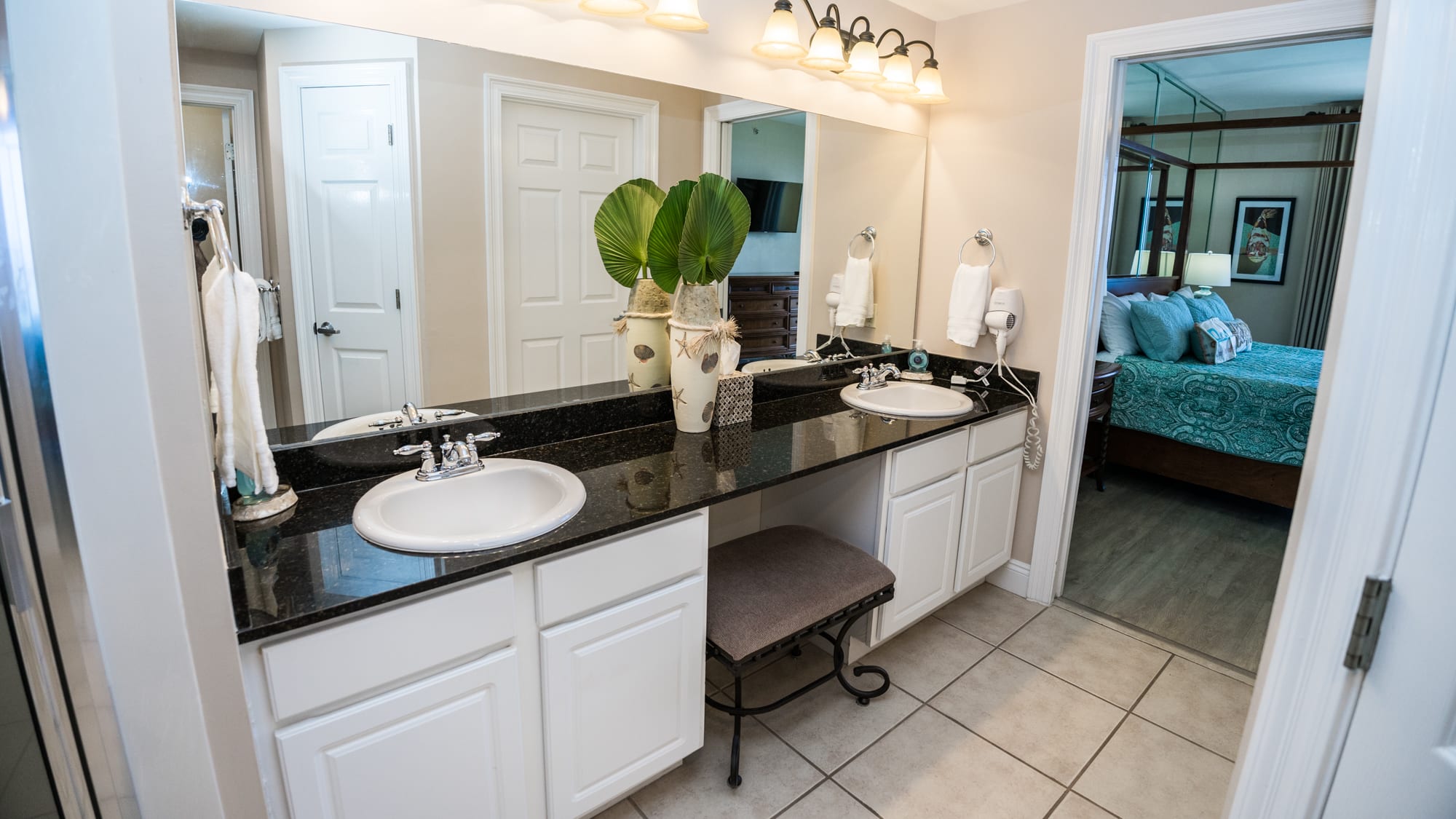 Another photo of the Double Sinks & Vanity. A pocket door closes off the bath area from the bedroom.