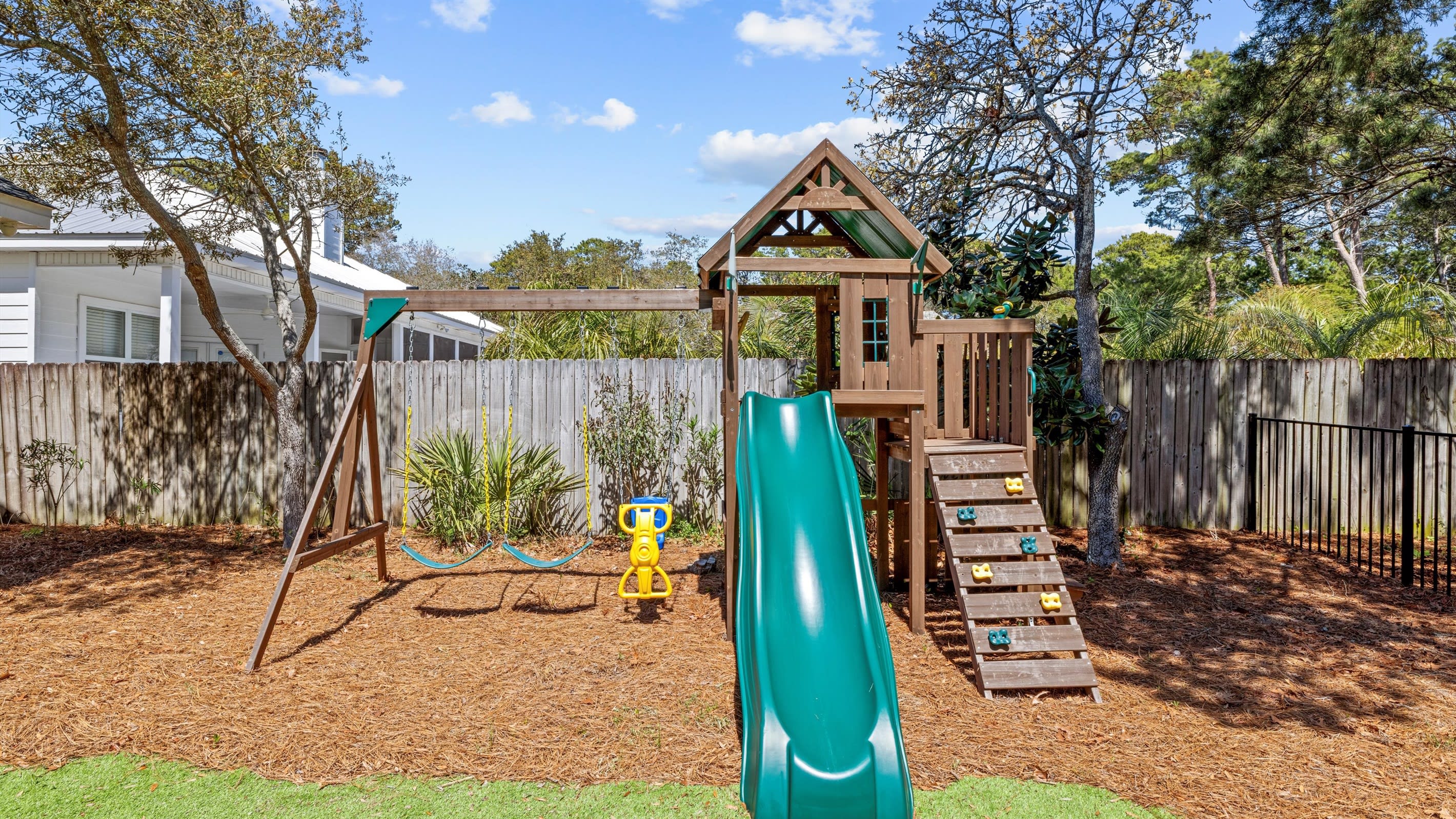 A backyard build for play, soft turf, a swing set, and a space place for the little ones to burn off energy.