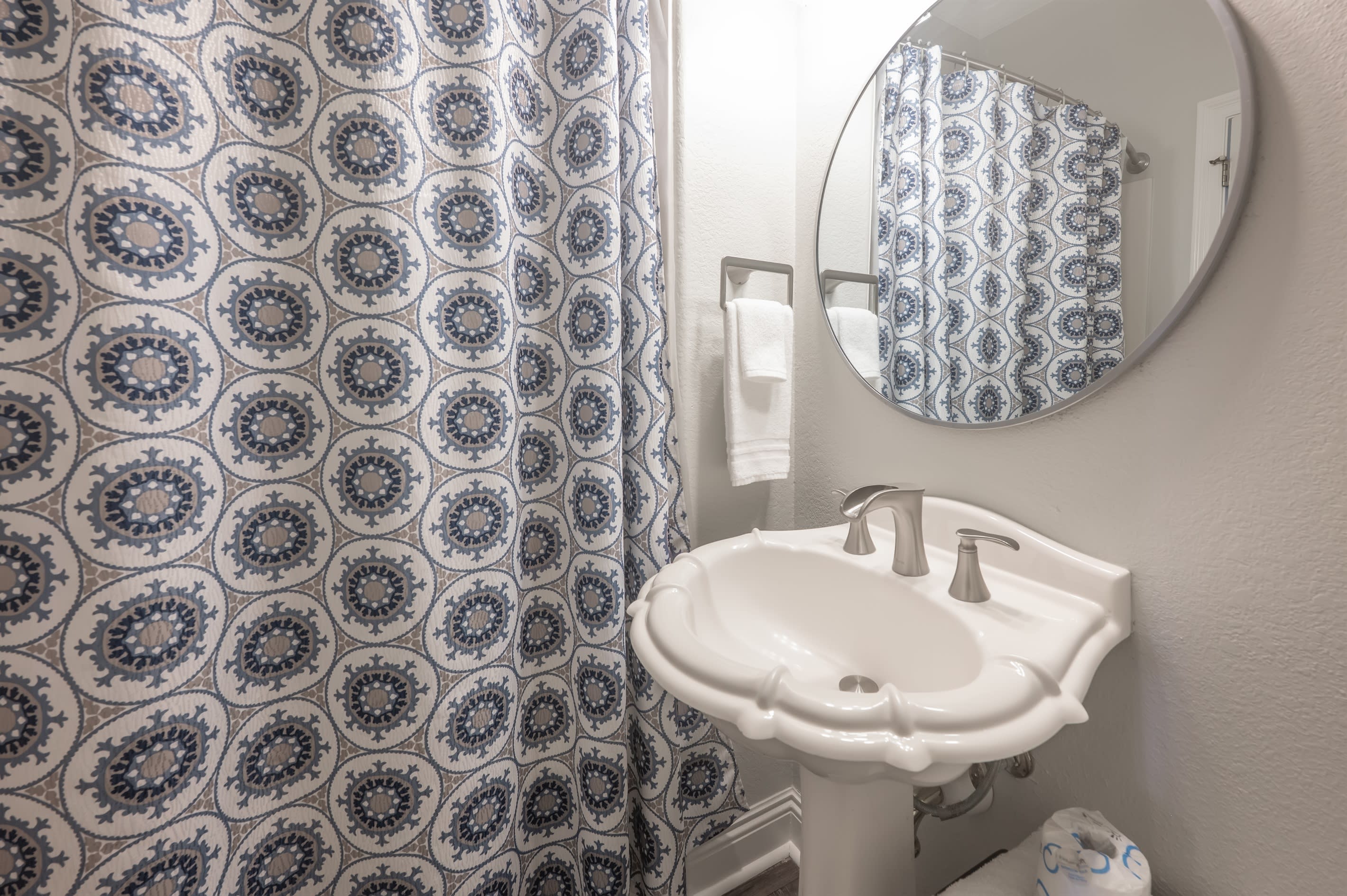 Patterned shower curtain adding visual interest to the bathroom.