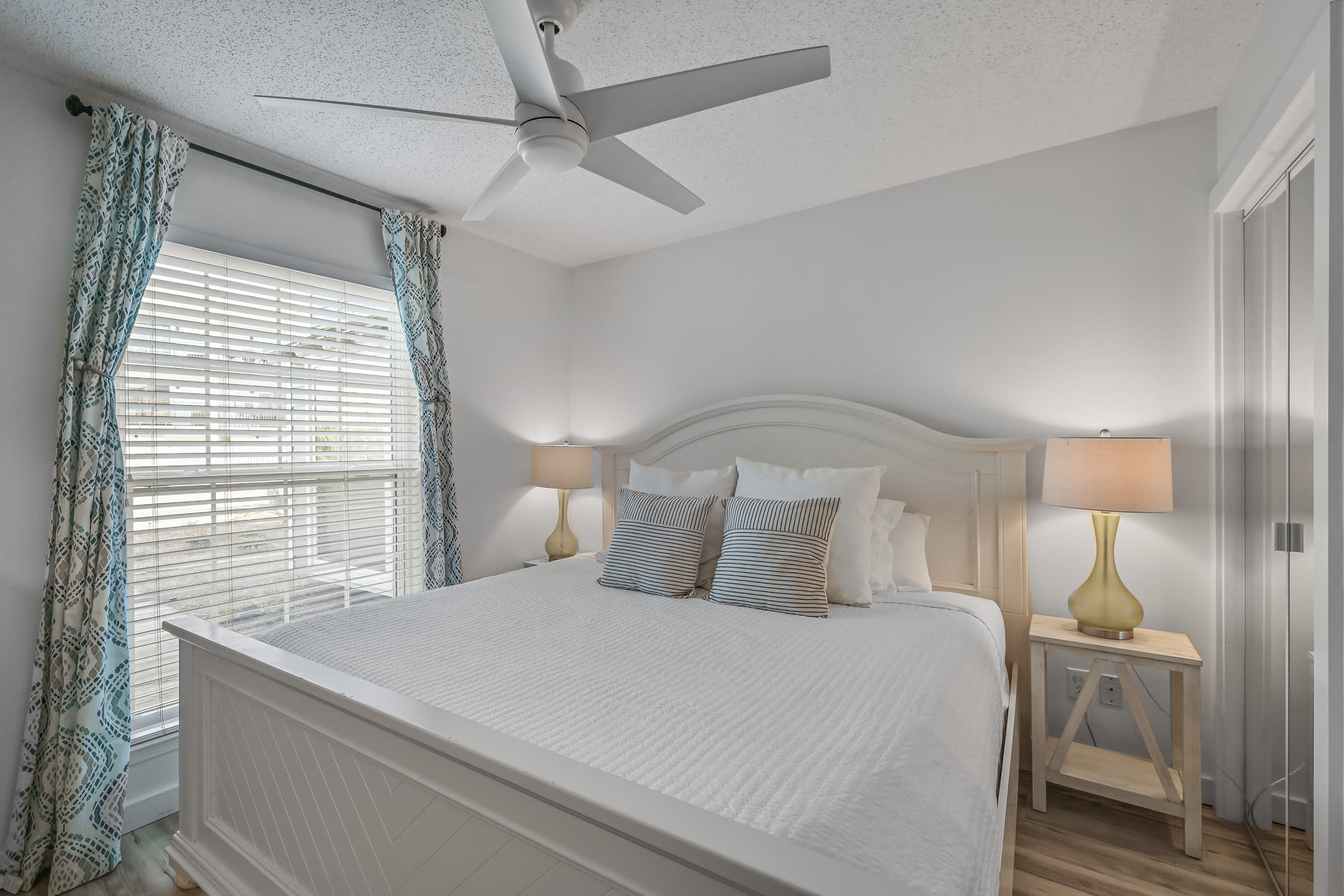 Bright, airy, and cozy master bedroom. Luxurious king bed,  adjustable ceiling fan, smart TV and blinds. Extra pillow and blankets are always an option for the utmost comfort! 