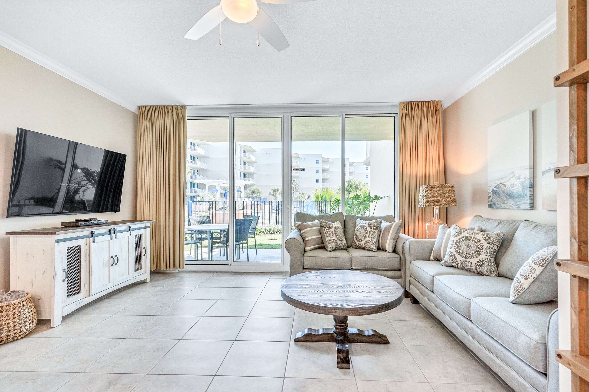 Blackout curtains with views of the upper heated pool, and garden landscaping. 