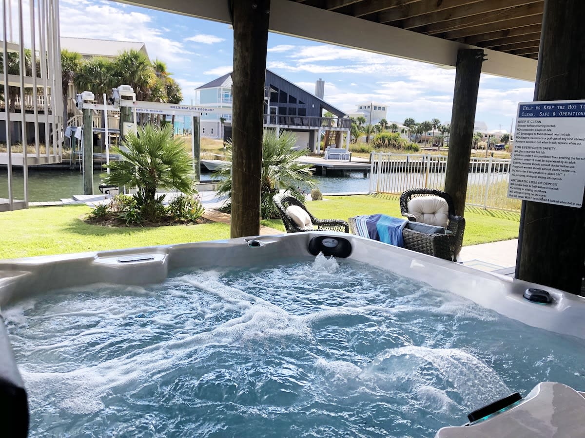 Welcome to Your WATERFRONT Island Retreat with PRIVATE Hot Tub & Backyard Oasis!