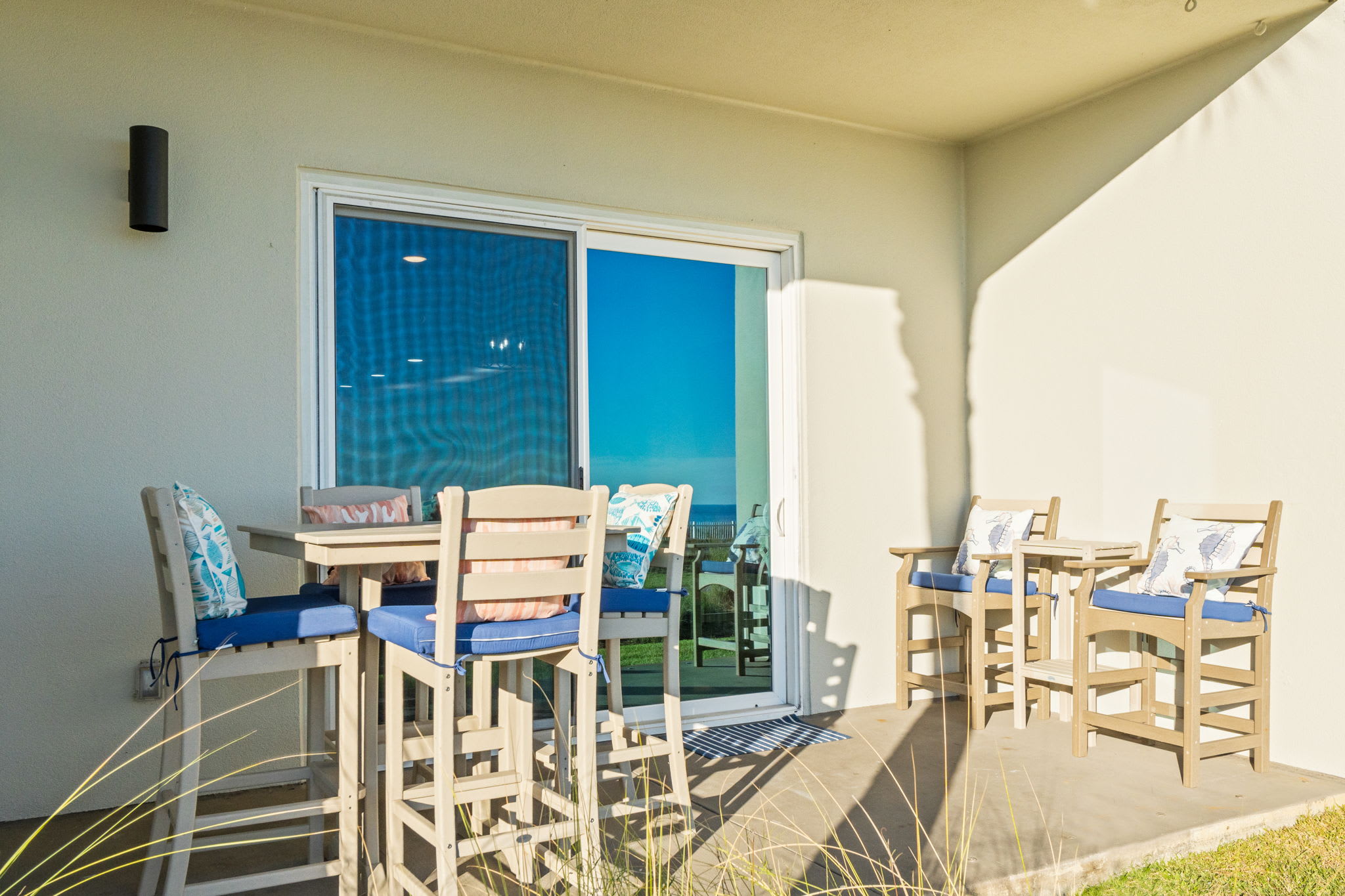 Outdoor dining and lounge area just 20 steps from the sugar sands of the Gulf