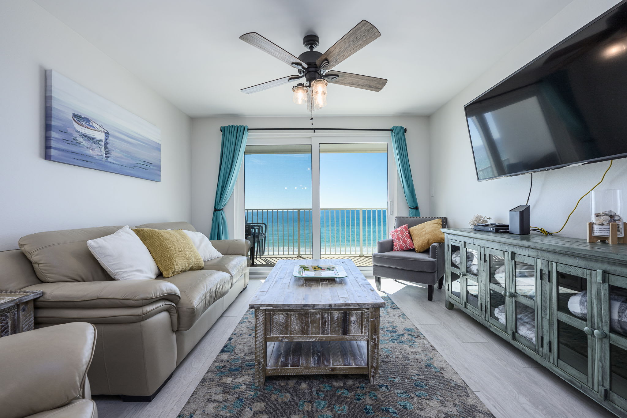 Living Room with Breathtaking Views Relax in this stylish living area, featuring plush seating, coastal decor, and a large flat-screen TV. The sliding glass doors lead to your private balcony,
