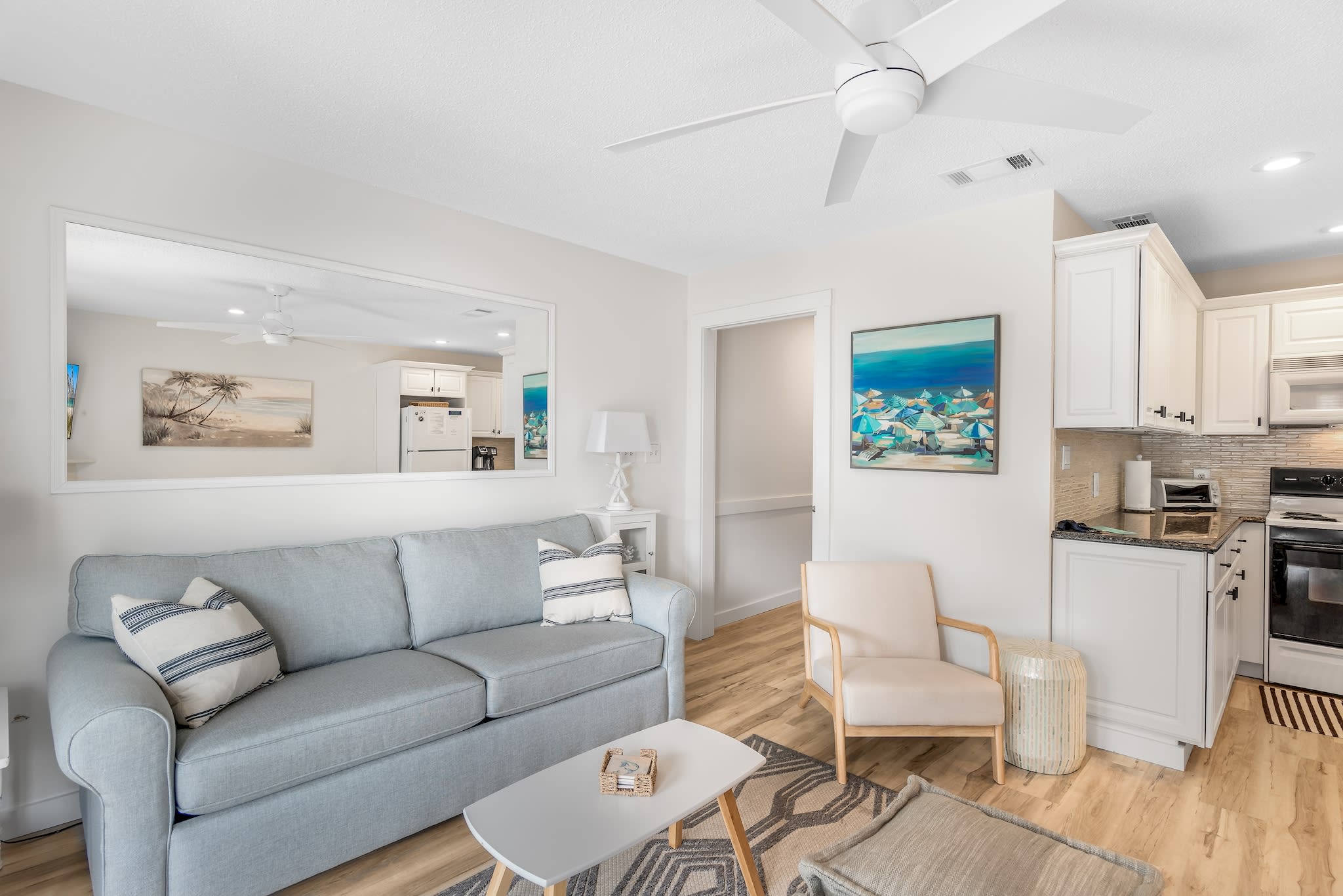 Cozy living room space with a comfy sleeper sofa, unlike others. Beachy accents and a ceiling fan to stay comfortable no matter the climate outdoors. 