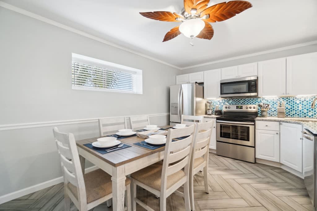 Dining table seats up to 6 guests with six bar stools surrounding the bar.