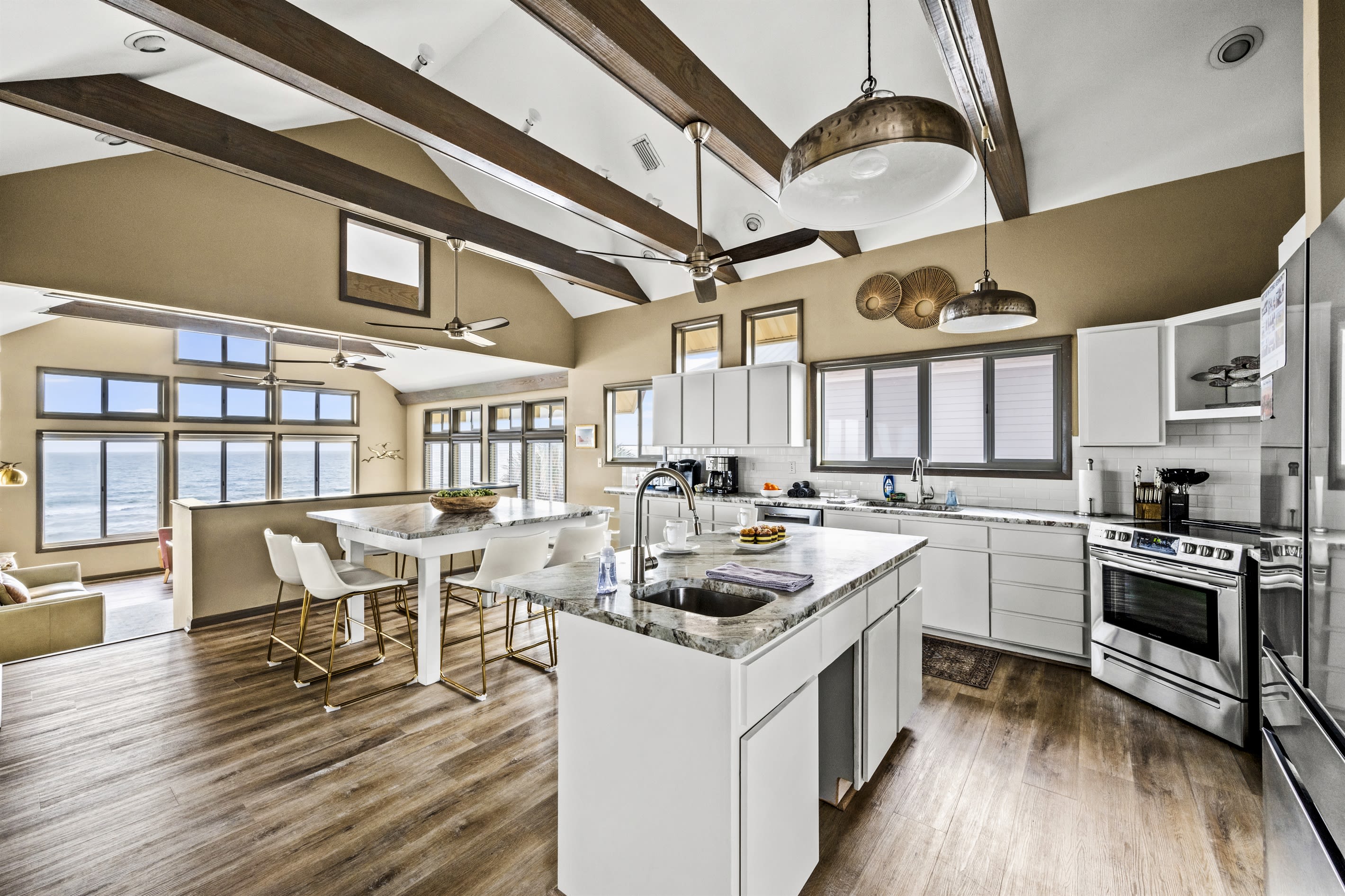 Cook and entertain in style in this open-plan kitchen with a large island, top-of-the-line amenities, and a seamless blend with the sitting area. Both areas offer stunning ocean views, making