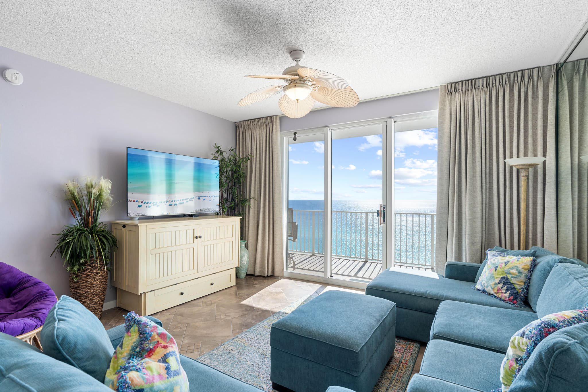 Inviting living room w/ plush sectional, TV & sliding doors opening to ocean views and fresh coastal breezes. Inviting living room w/ plush sectional, TV & sliding doors opening to ocean views and fresh coastal breezes.