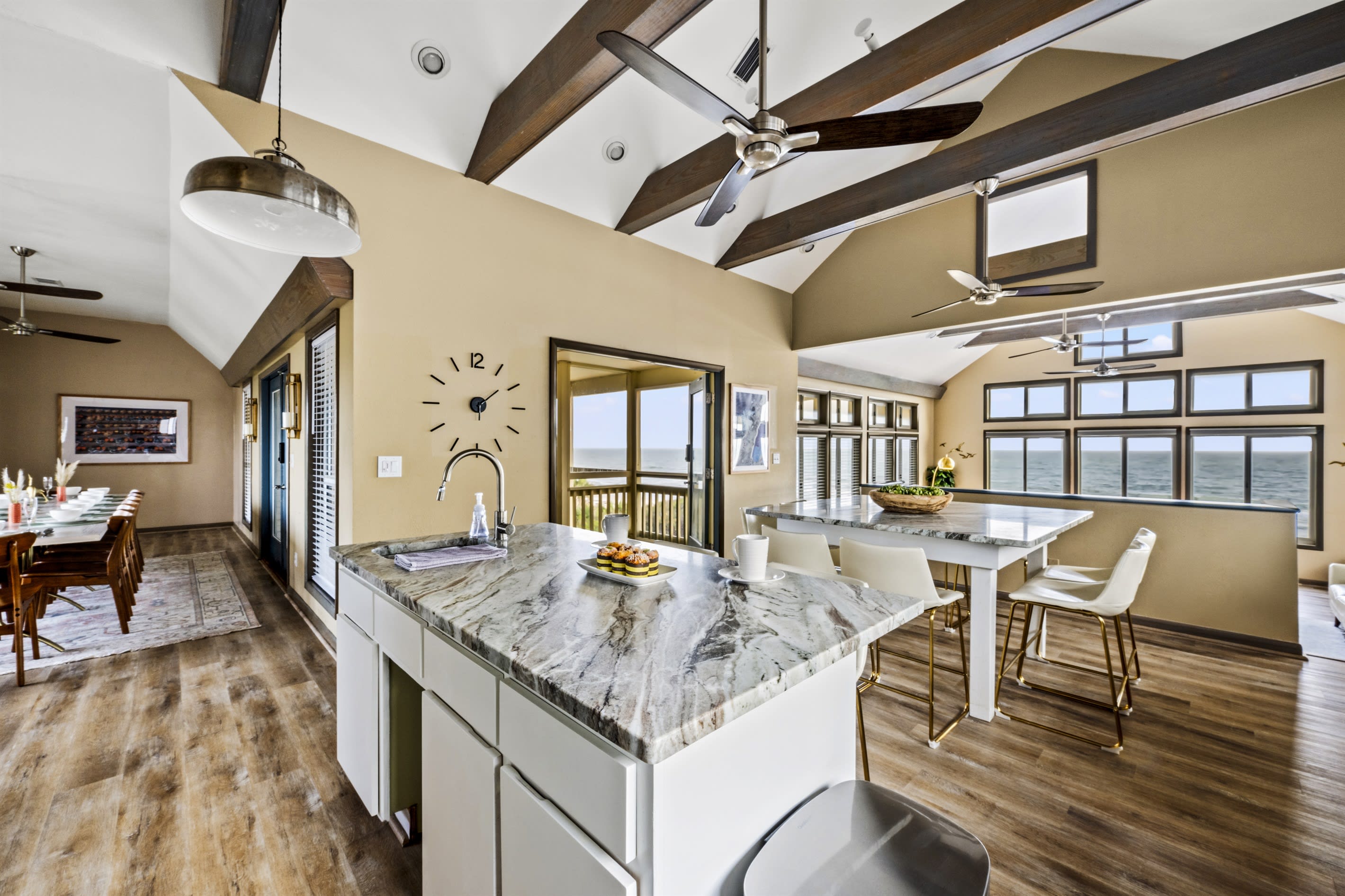 Enjoy dining in this open-concept kitchen featuring granite countertops, an abundance of natural light, and a sleek, modern design.